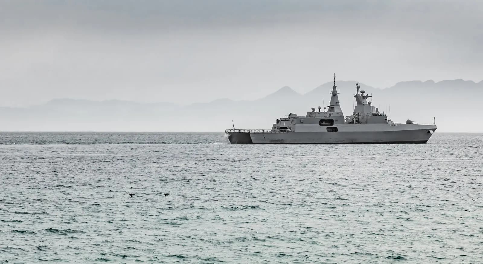 Modern naval frigate under way at sea