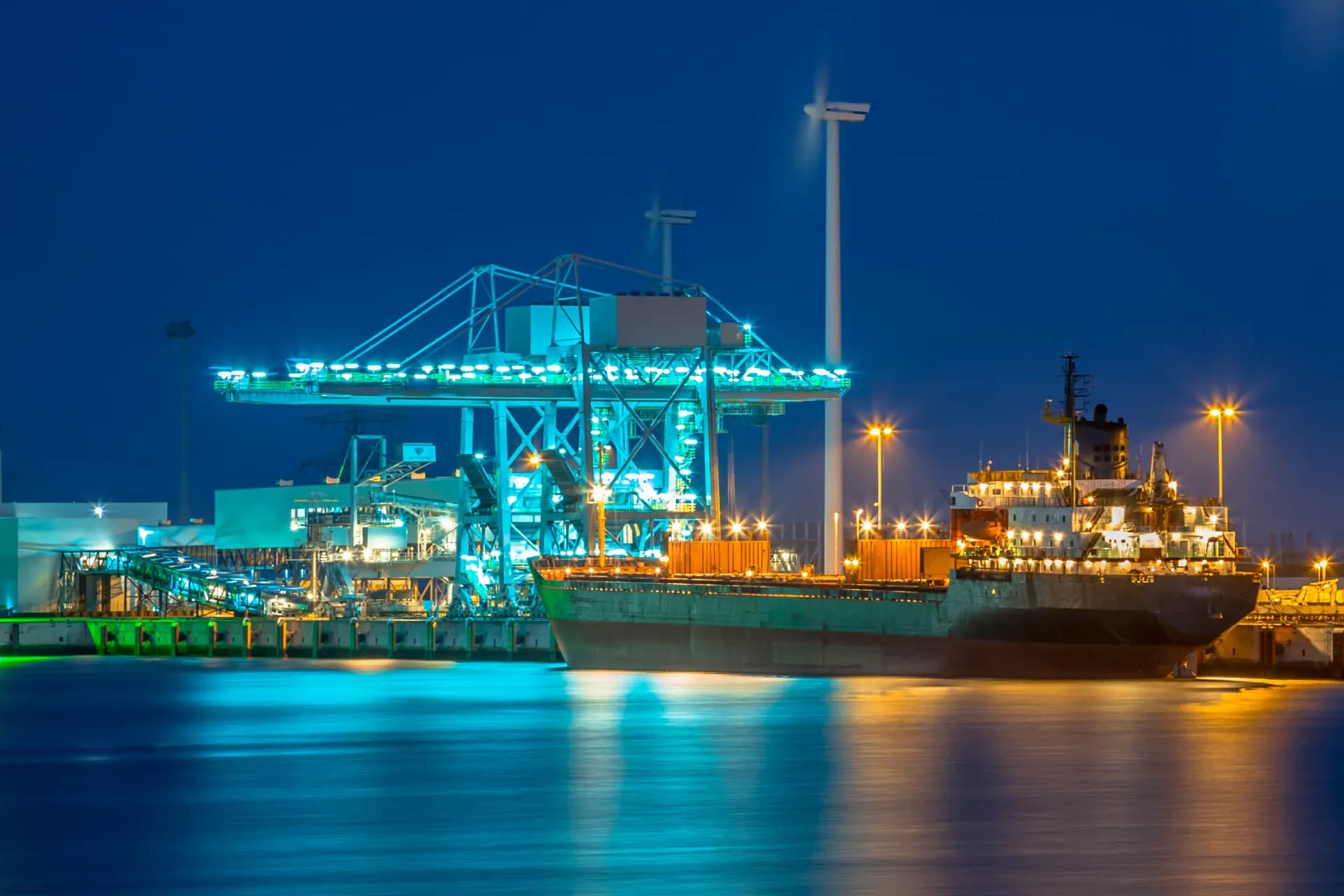 A cargo ship in harbour at night