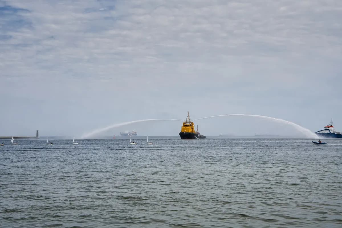 Harbour tug at work spraying water