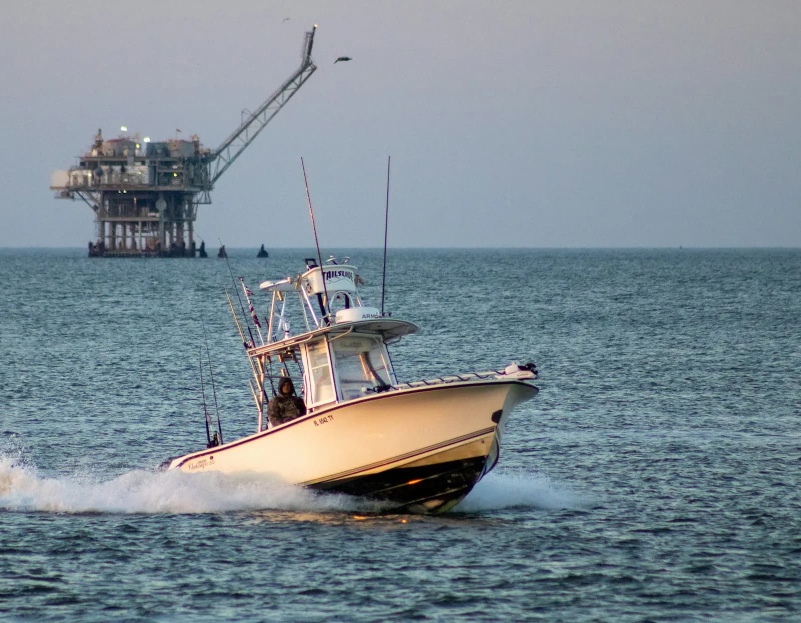 Offshore support vessel working near a platform at sea