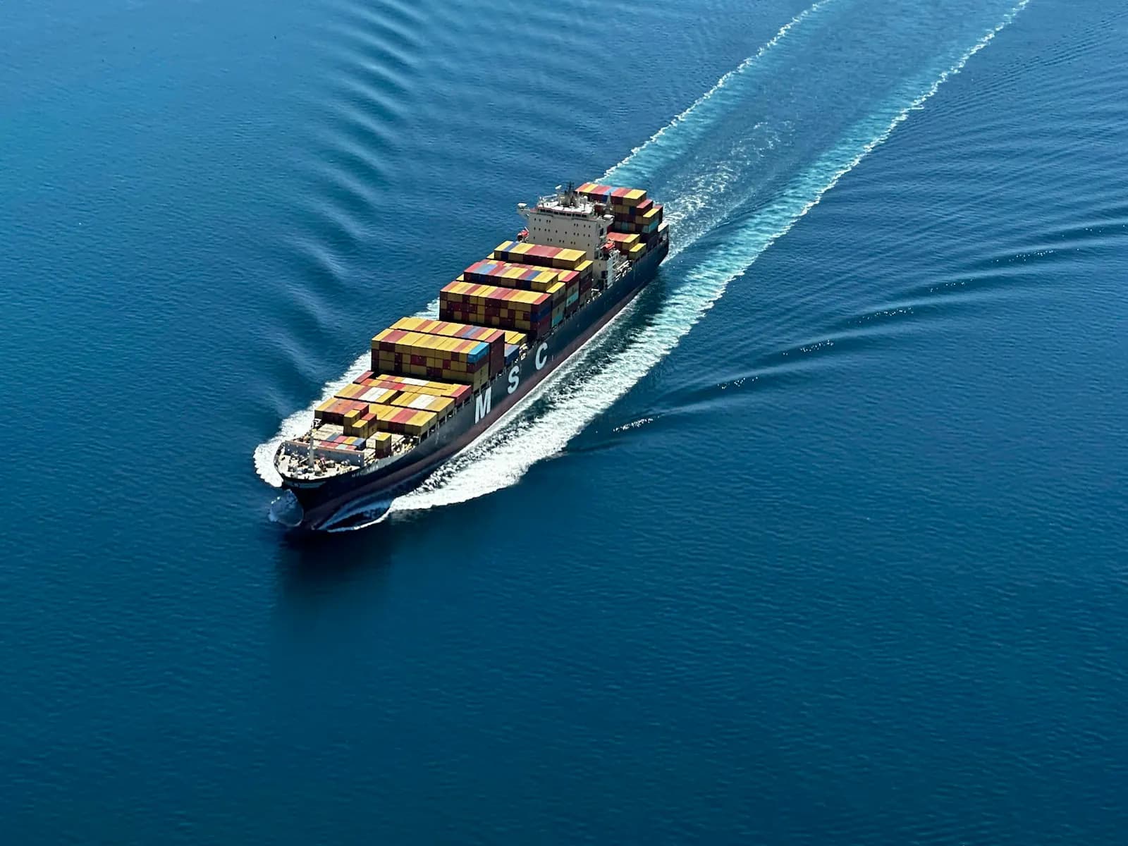 A container ship transiting a canal waterway