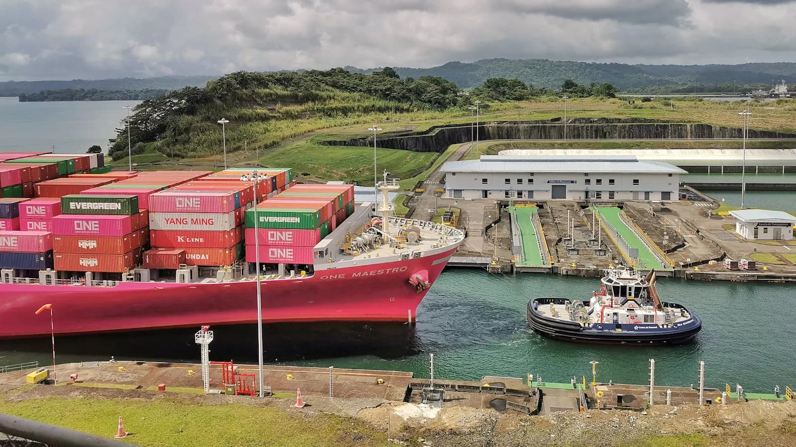 A cargo ship transiting a busy shipping canal