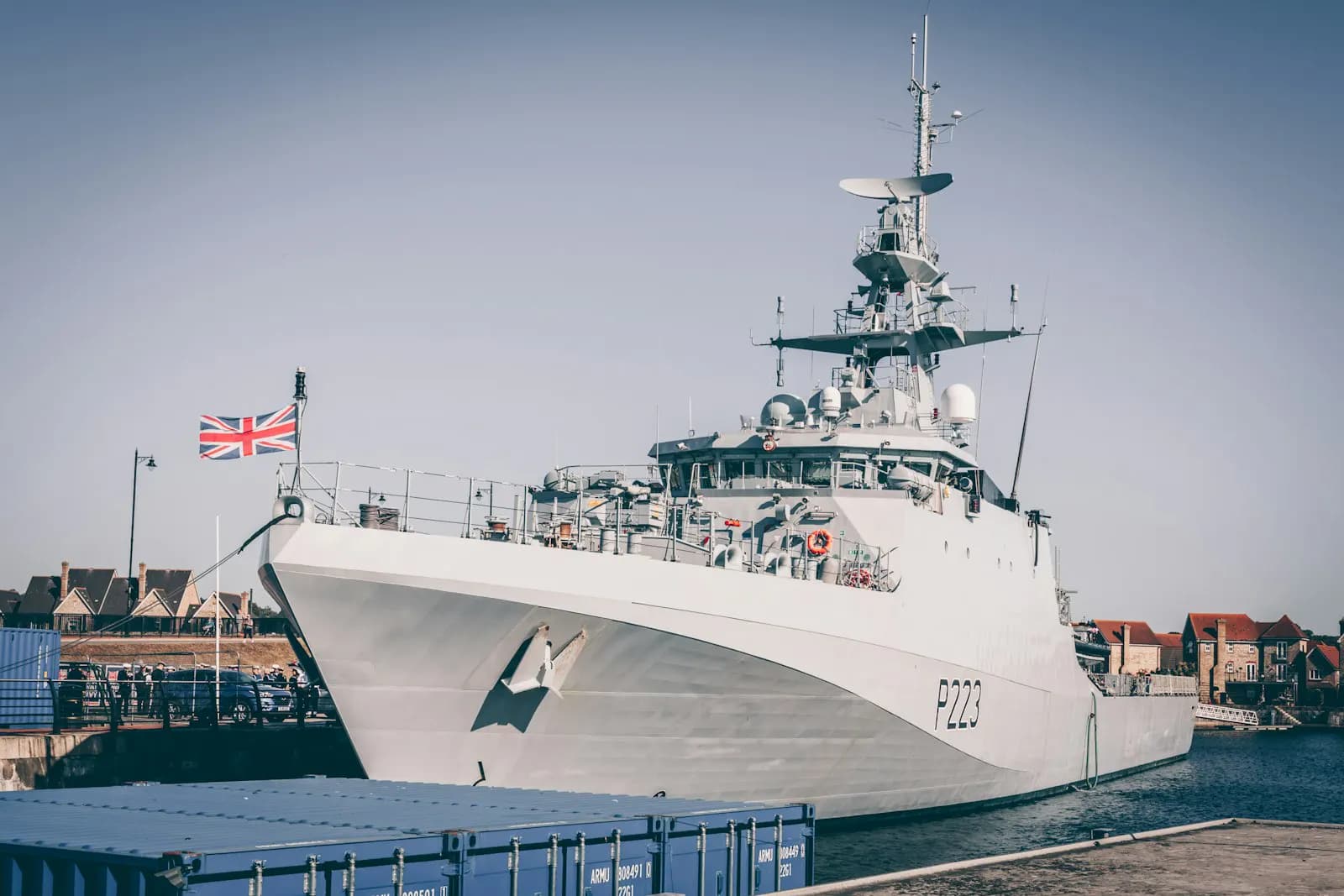 A modern naval corvette at a commissioning ceremony