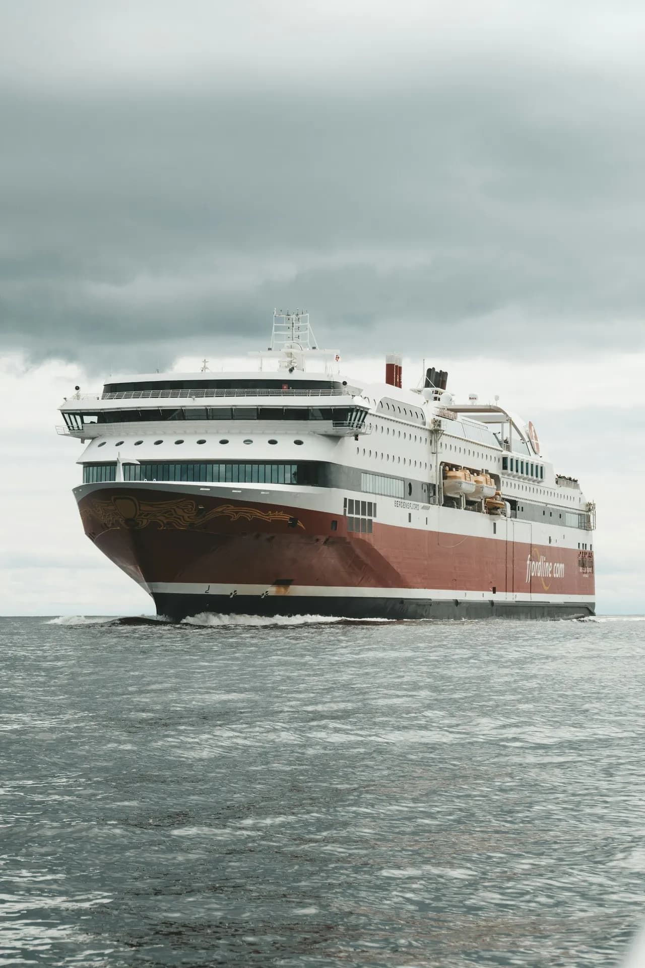 Large passenger ferry sailing at sunset