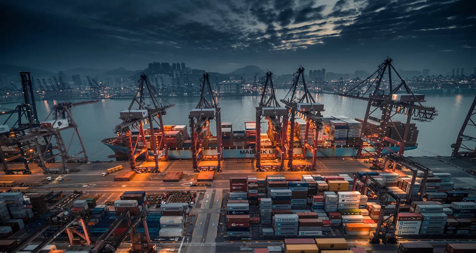 Container terminal with cranes lit at night