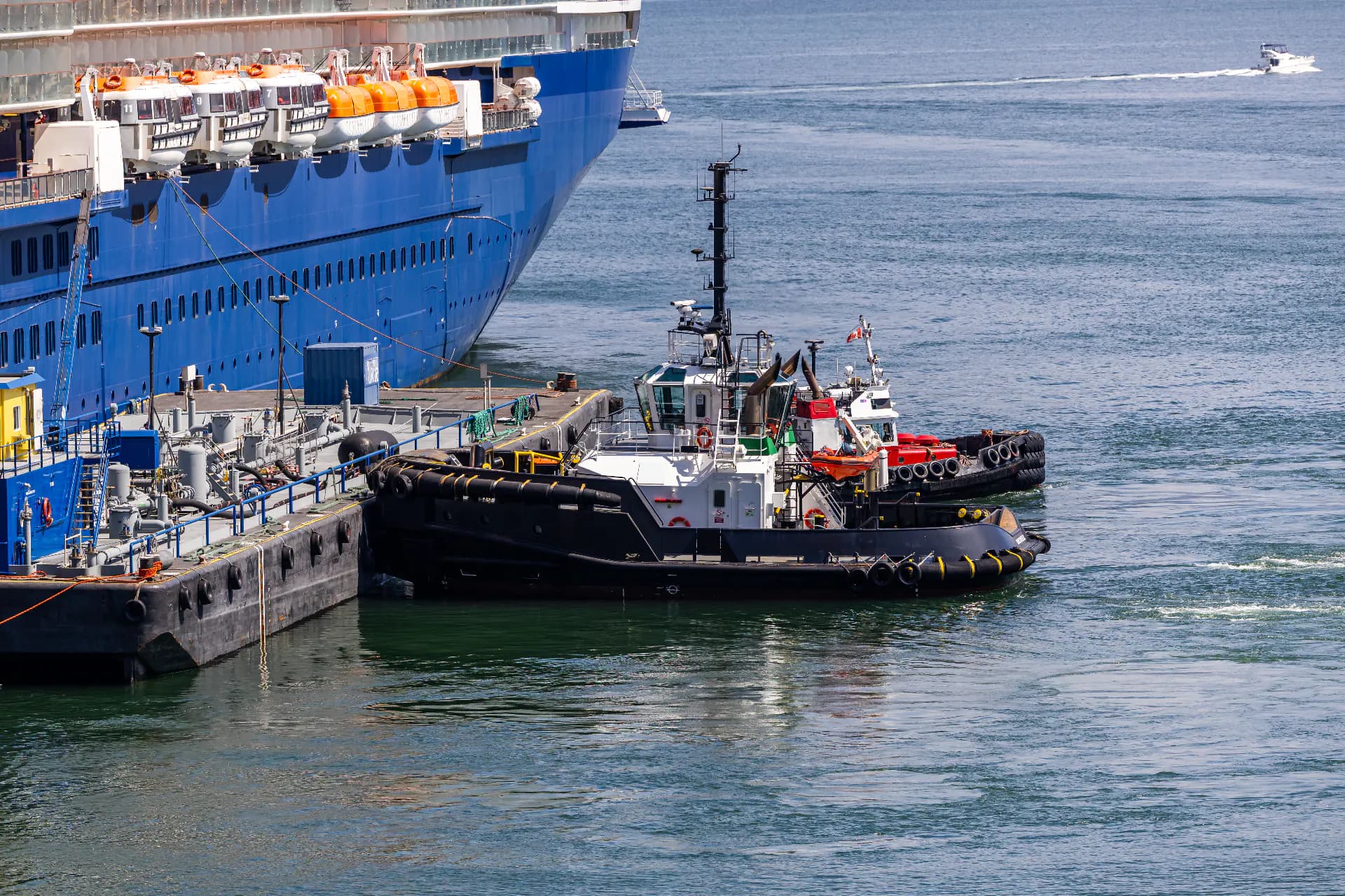 Harbour tugs assisting a large vessel alongside