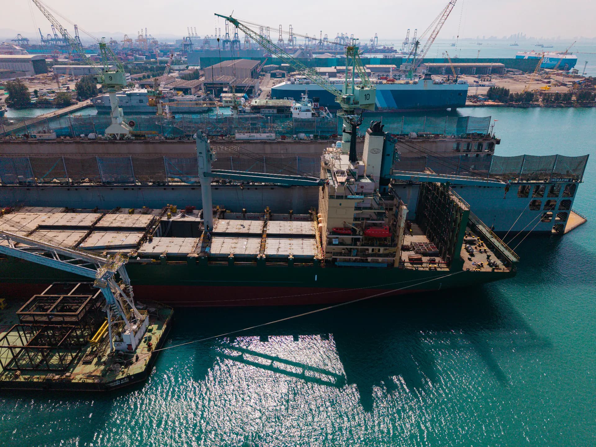 A large vessel under repair in a shipyard dry dock