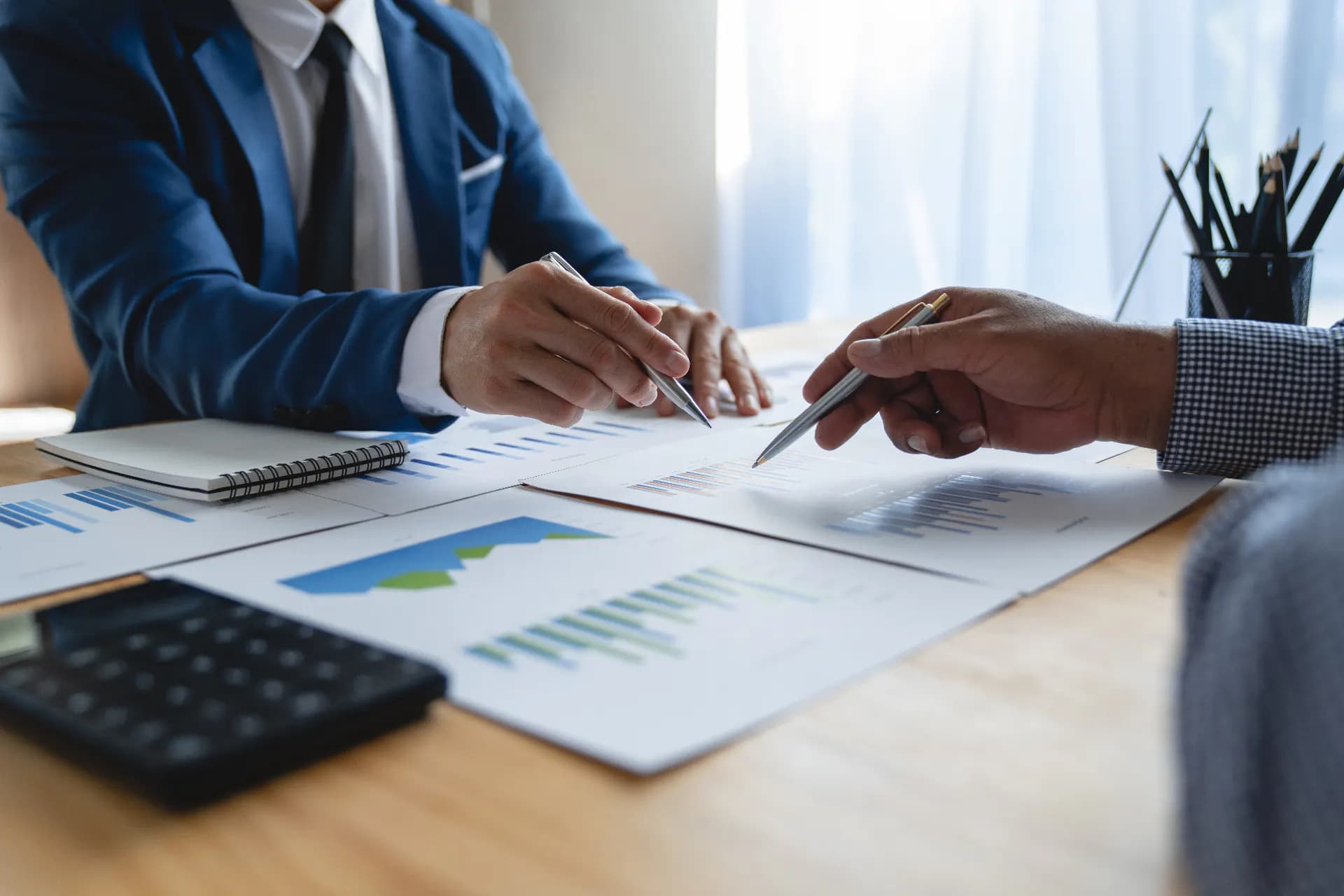 Financial charts and data reviewed in a meeting