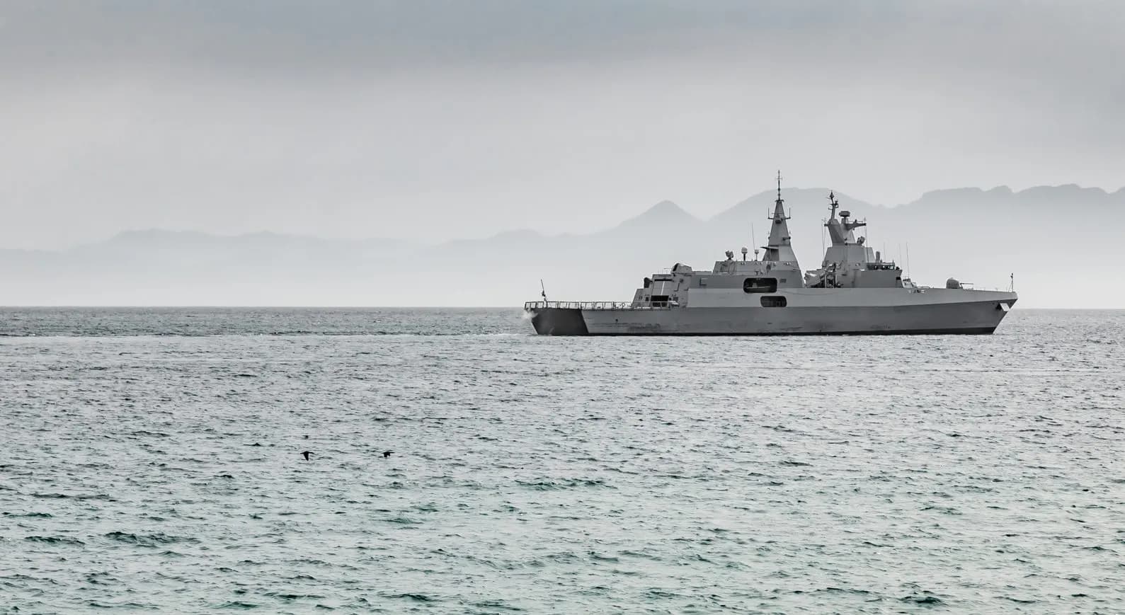 Naval vessels alongside, illustrating submarine and warship programmes