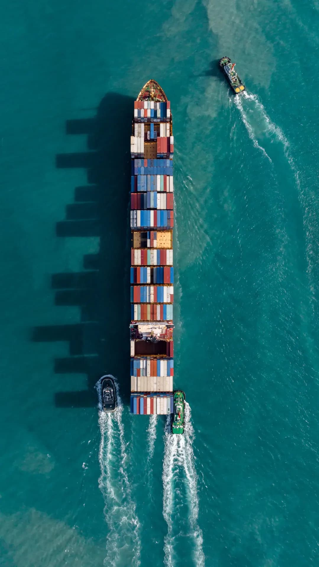 Aerial view of a container ship under way, illustrating global container shipping operations