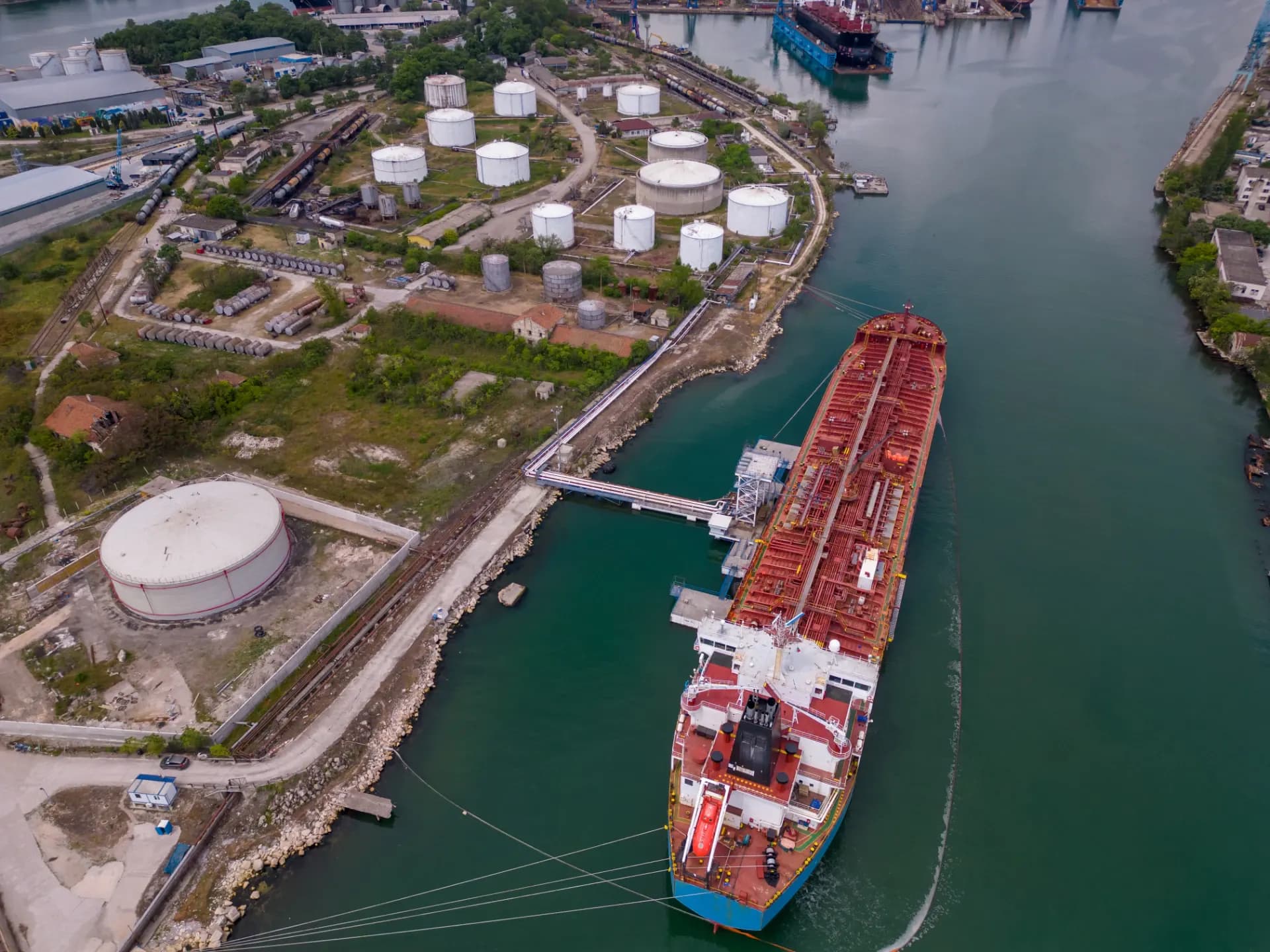 A gas carrier and a tanker at an industrial terminal