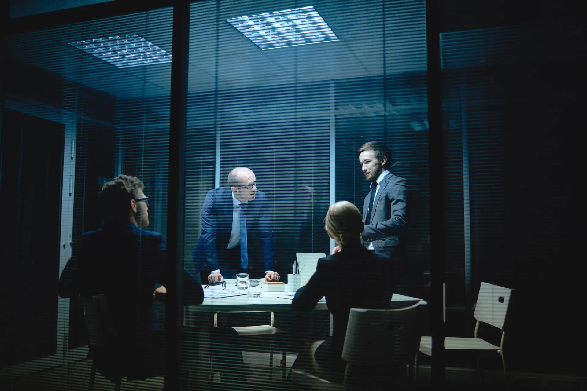 Delegates in a boardroom at night, illustrating international regulatory negotiations