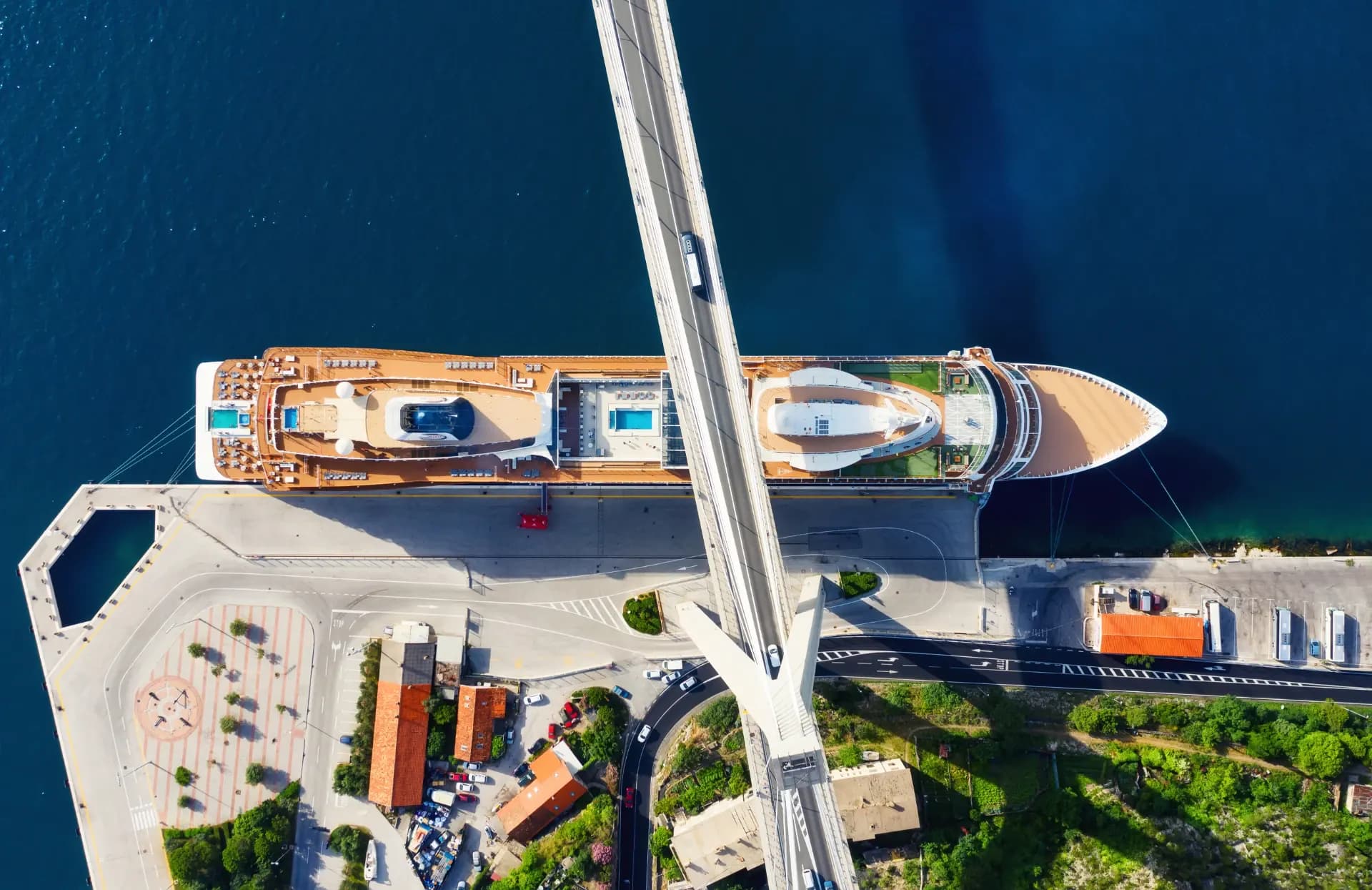 A ship passing beneath a road bridge, illustrating bridge transits by commercial vessels