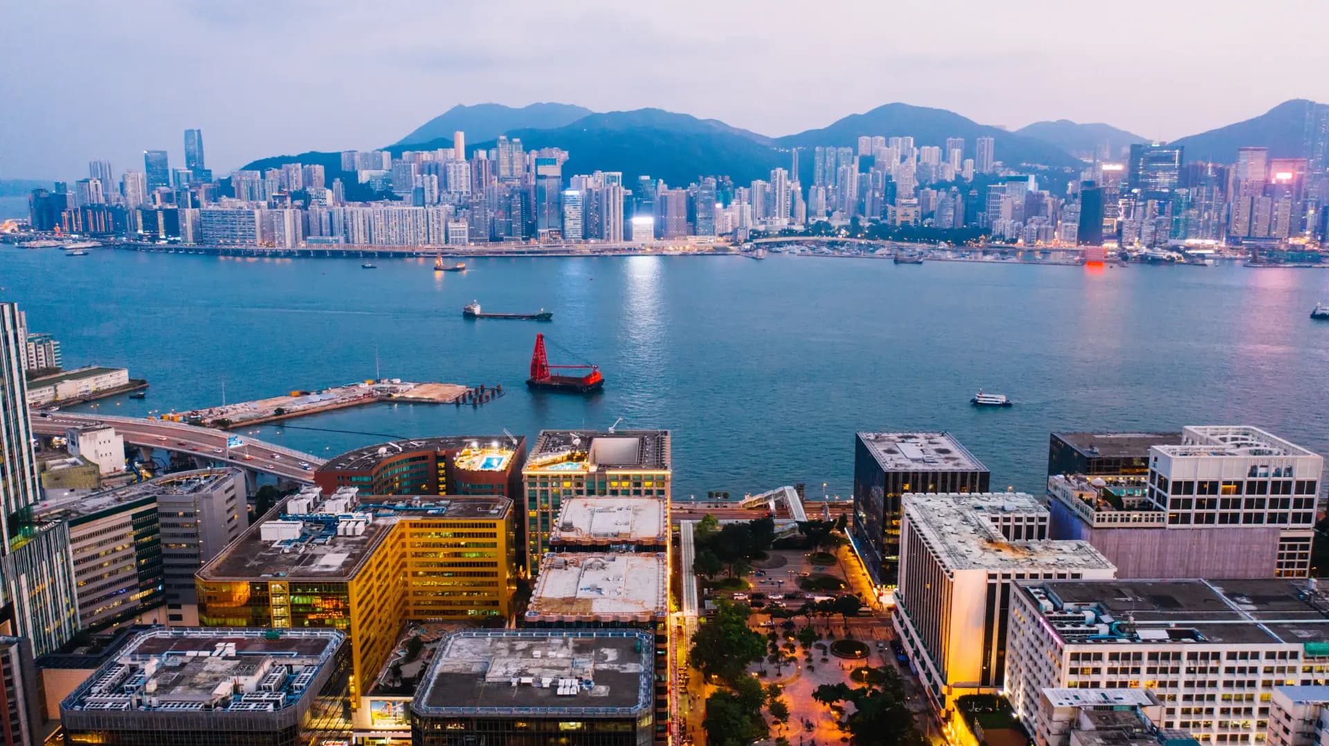 Power infrastructure in an Asian city at dusk, illustrating electricity supply pressure