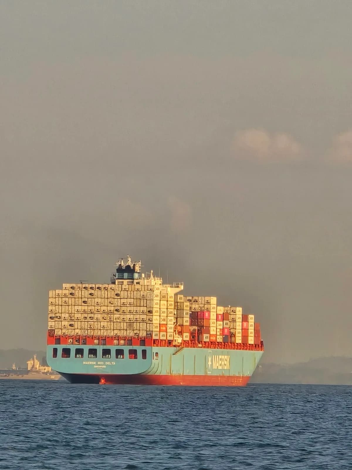 Container ship at sea at sunset