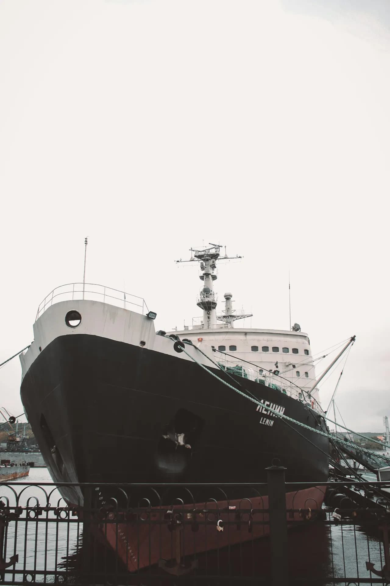 Large naval support vessel alongside at a dock