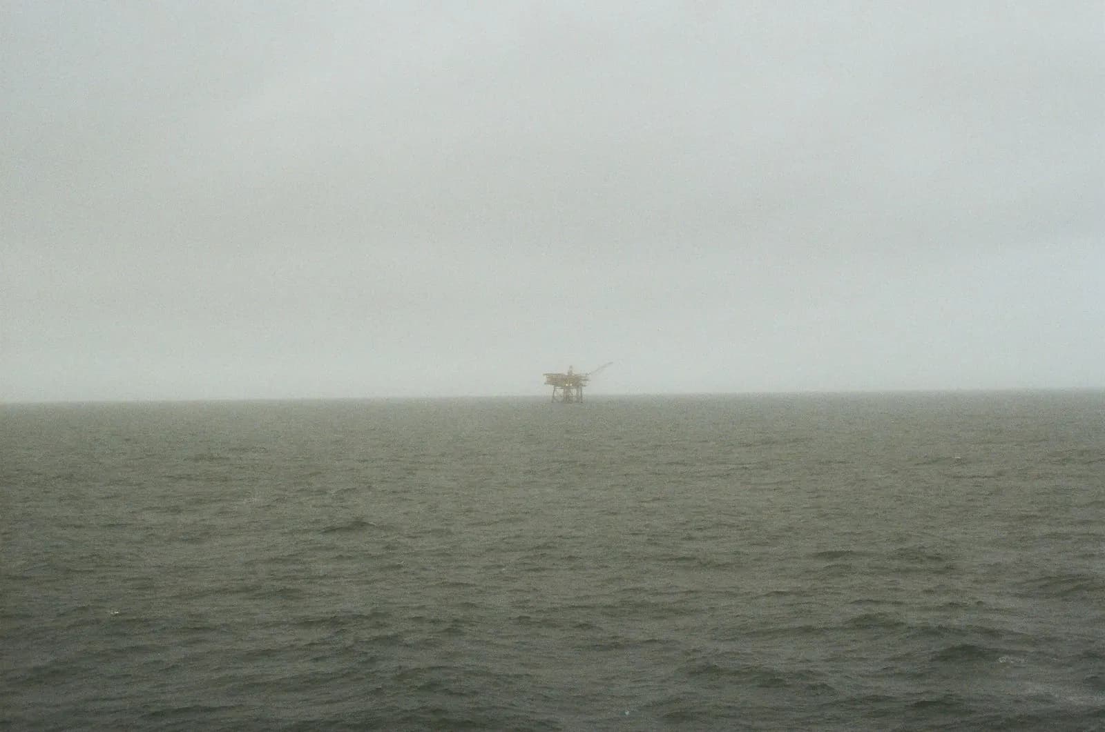 Offshore drilling rig at sea in foggy conditions