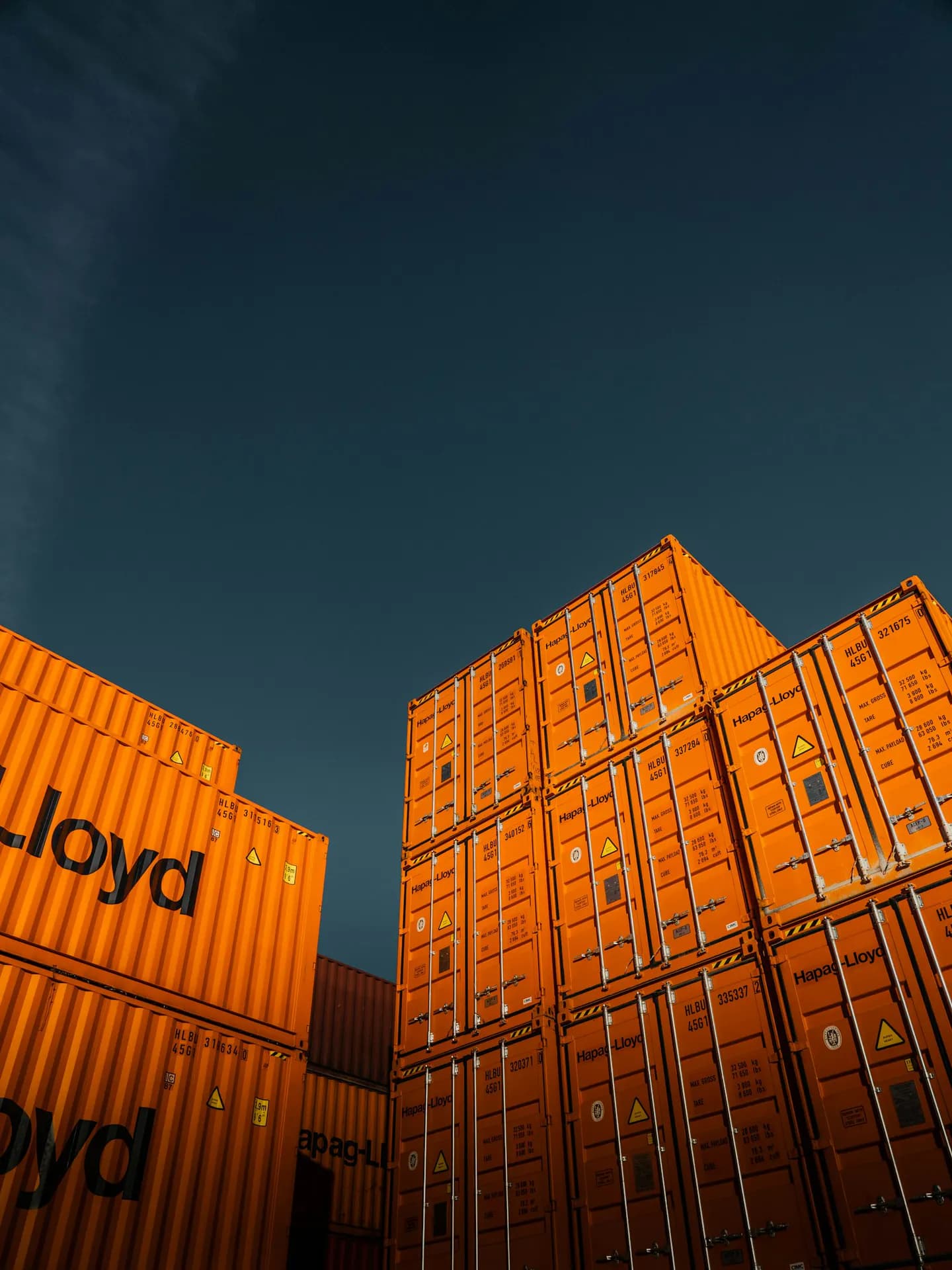 Stacked refrigerated shipping containers at a port terminal