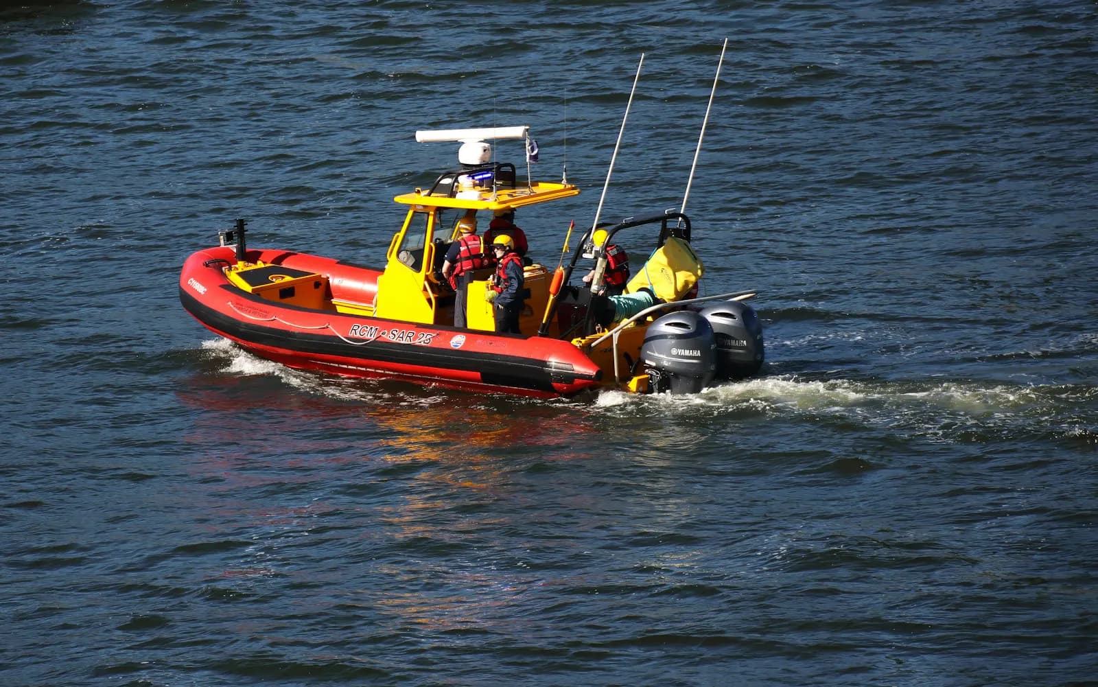 A search and rescue vessel operating at sea near a coastline