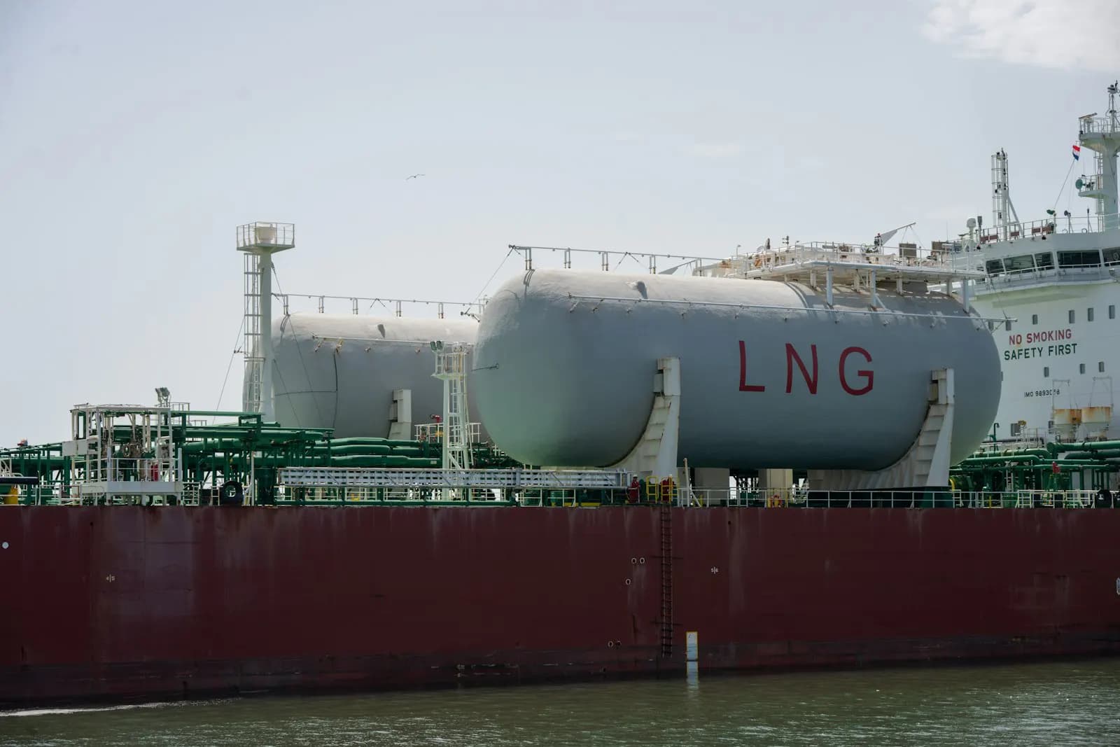 An LNG carrier underway with its cargo tanks visible