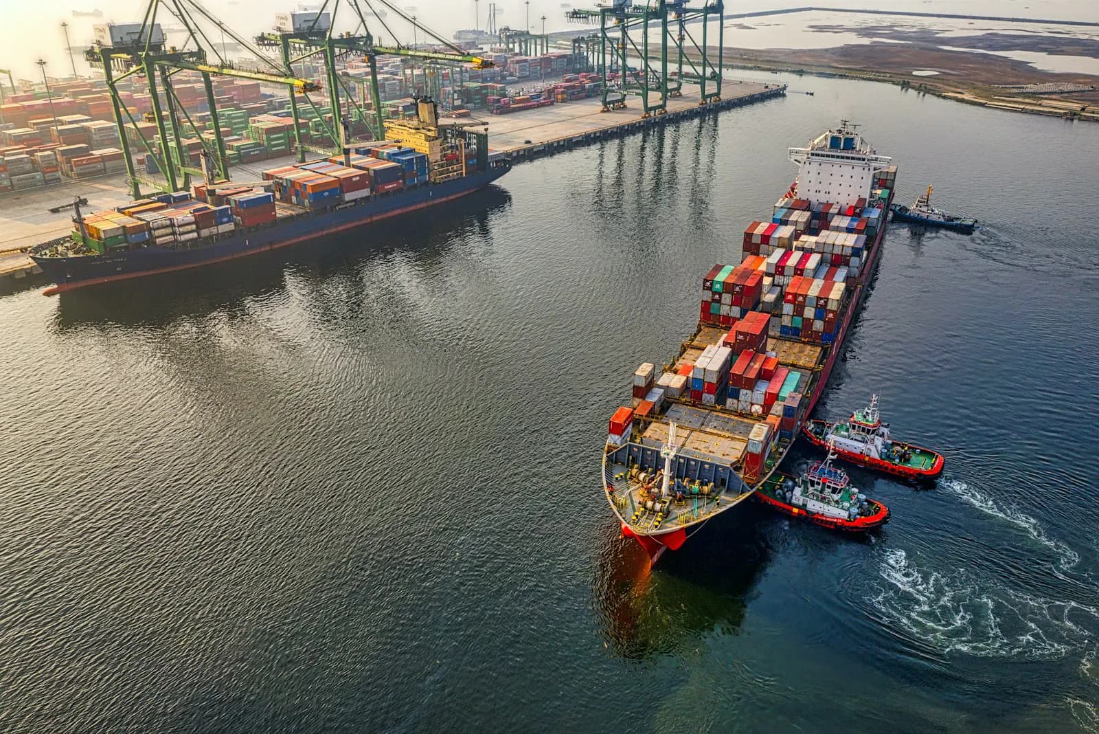 A wide shipping channel leading into a major container port