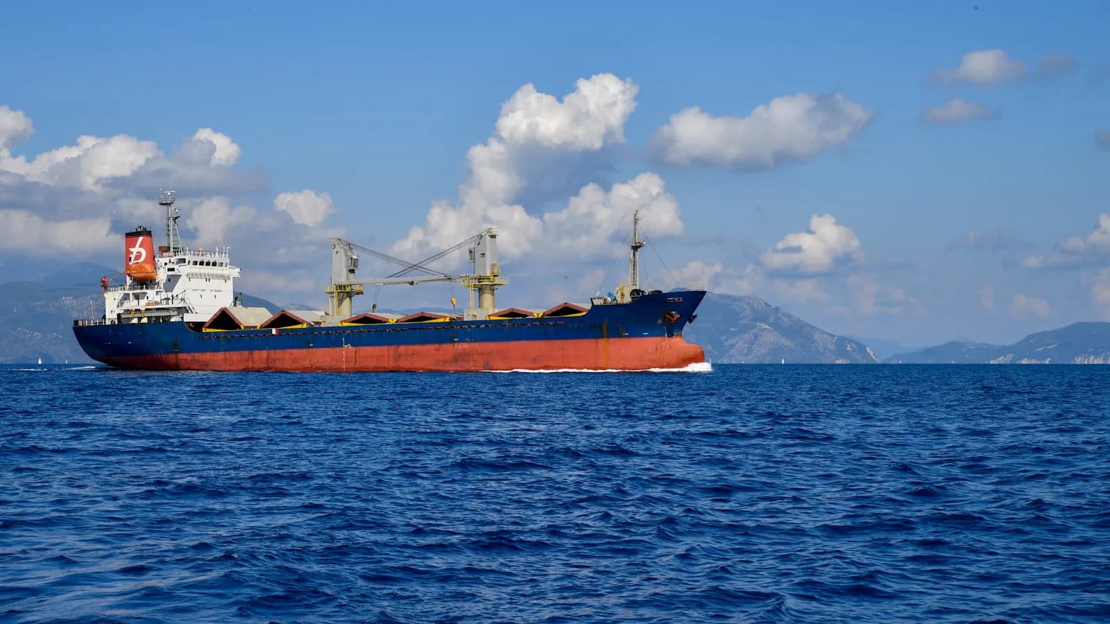 A small general cargo ship at sea