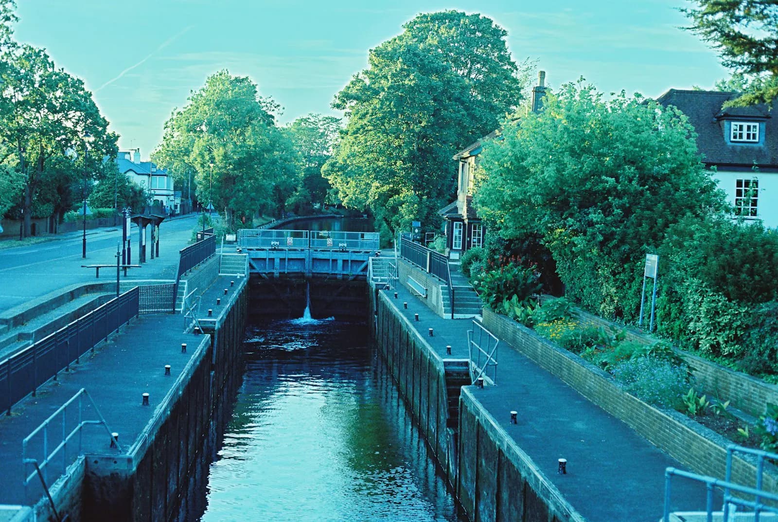 Canal lock with low water level surrounded by trees