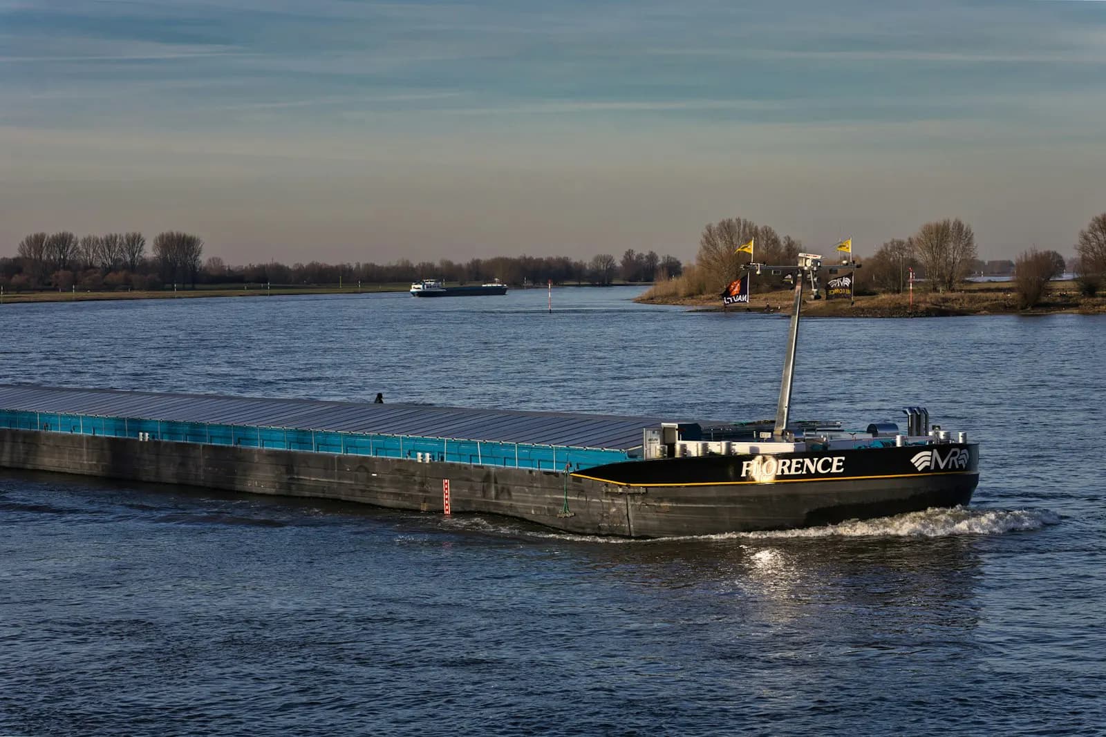 Inland tanker barge Florence sailing on a wide river