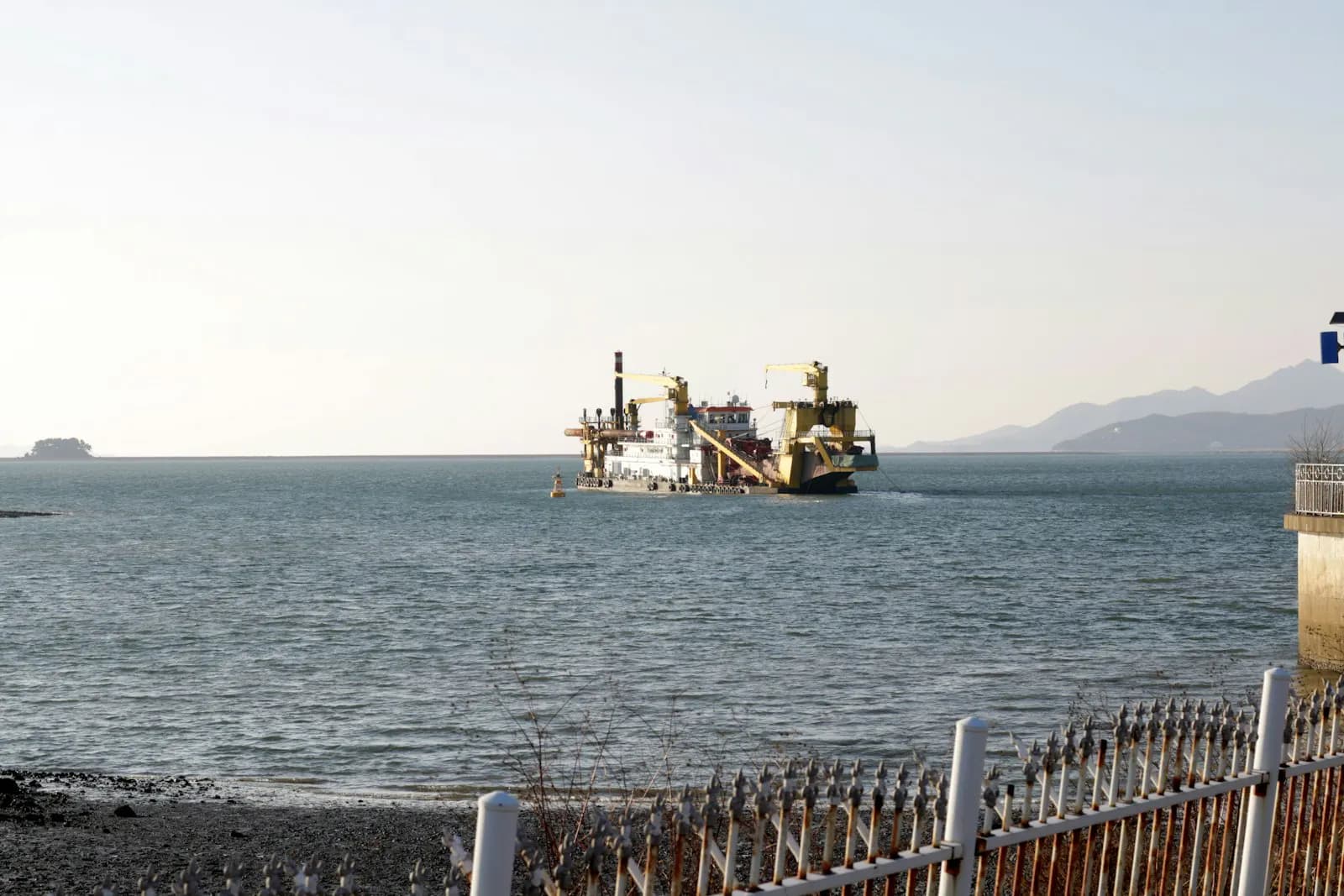 Cutter suction dredger working near a coastal waterway