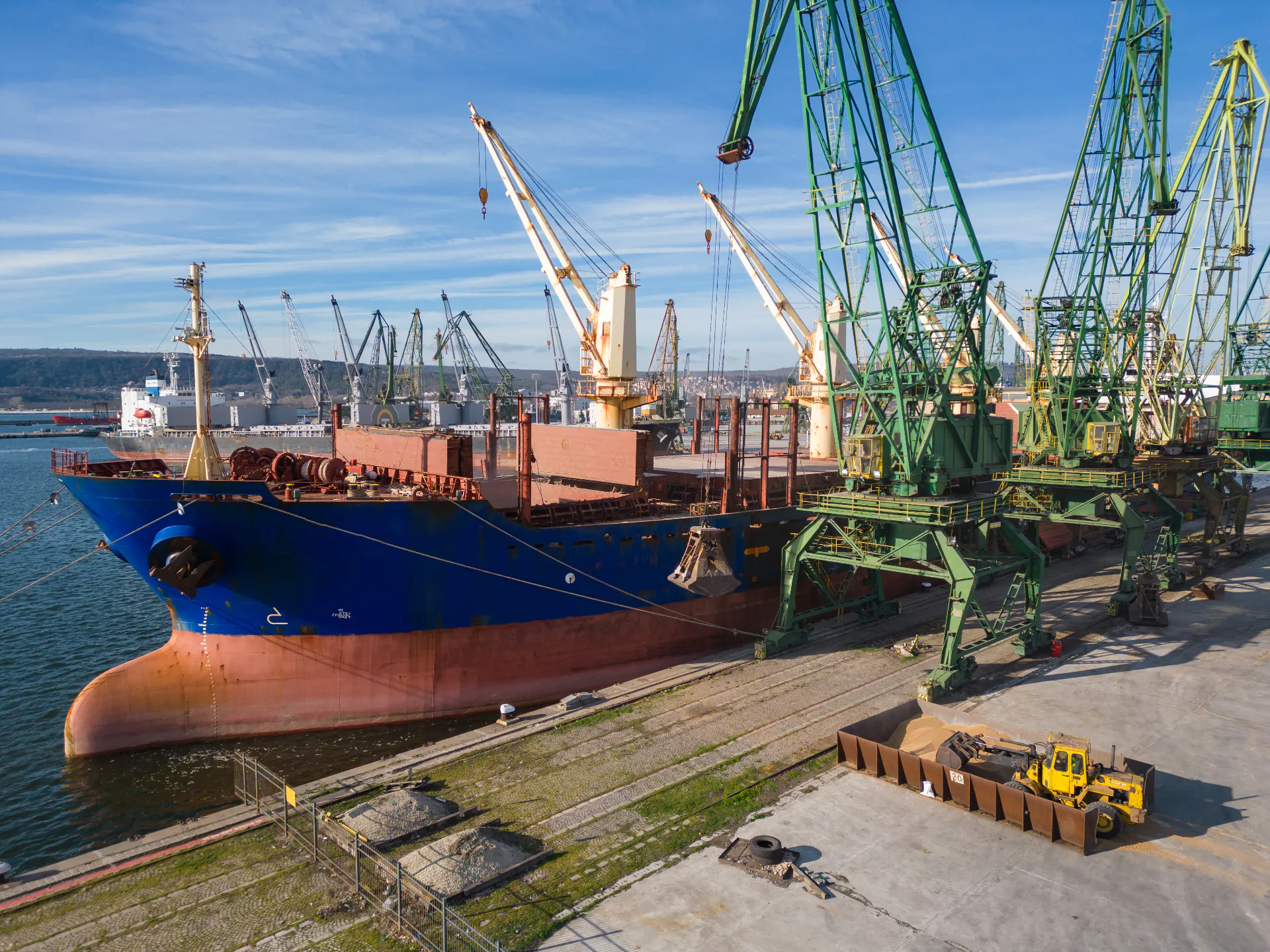A bulk carrier ship loaded with grain is docked at