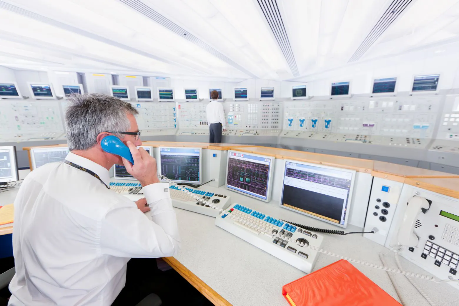A ship-operations control room with staff monitoring digital systems