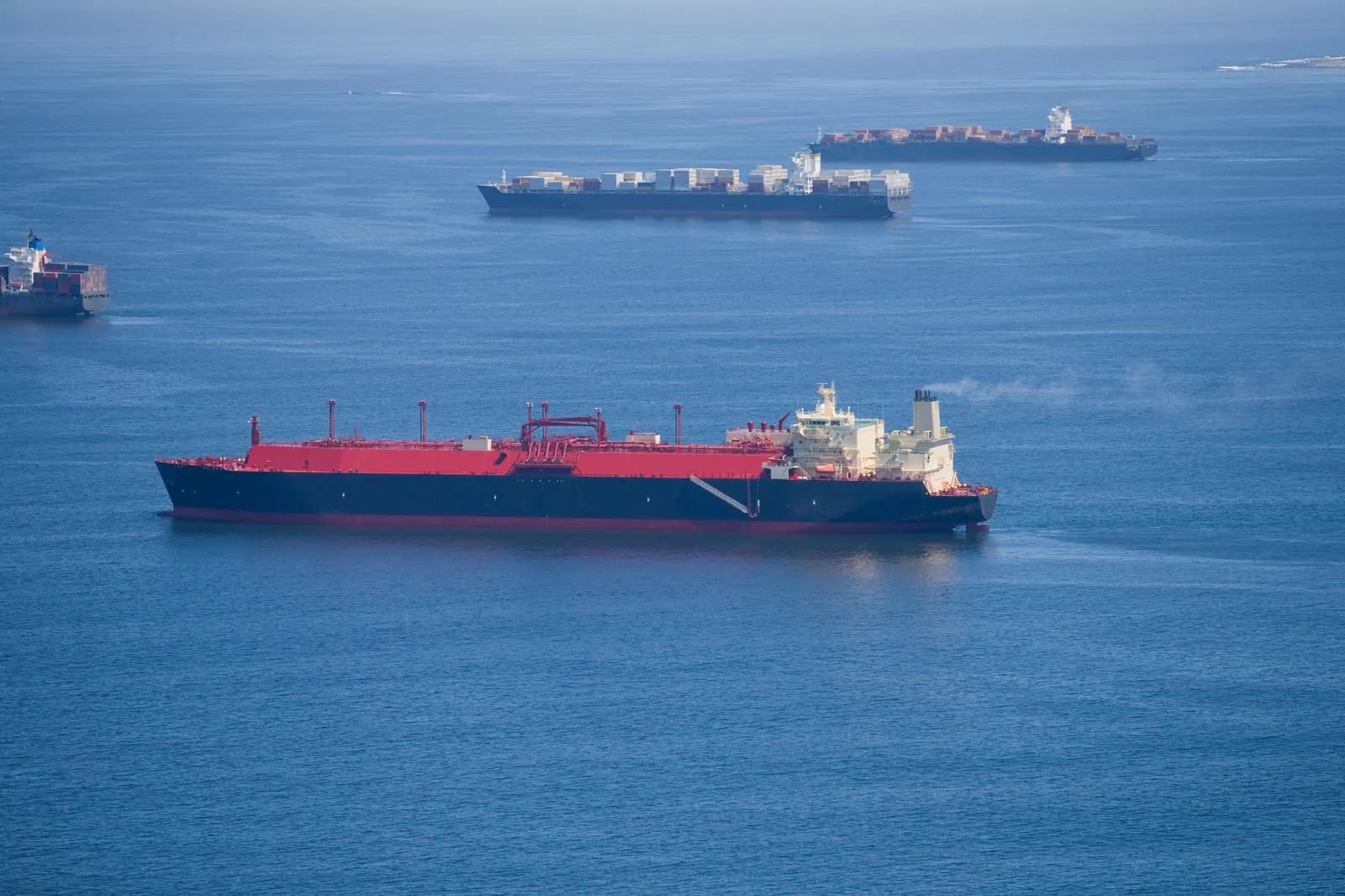 LNG carrier under way with vessels at anchor beyond