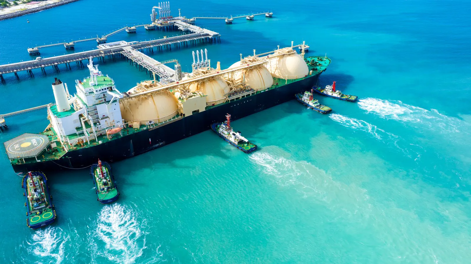 LNG carrier alongside a terminal with tugs in attendance