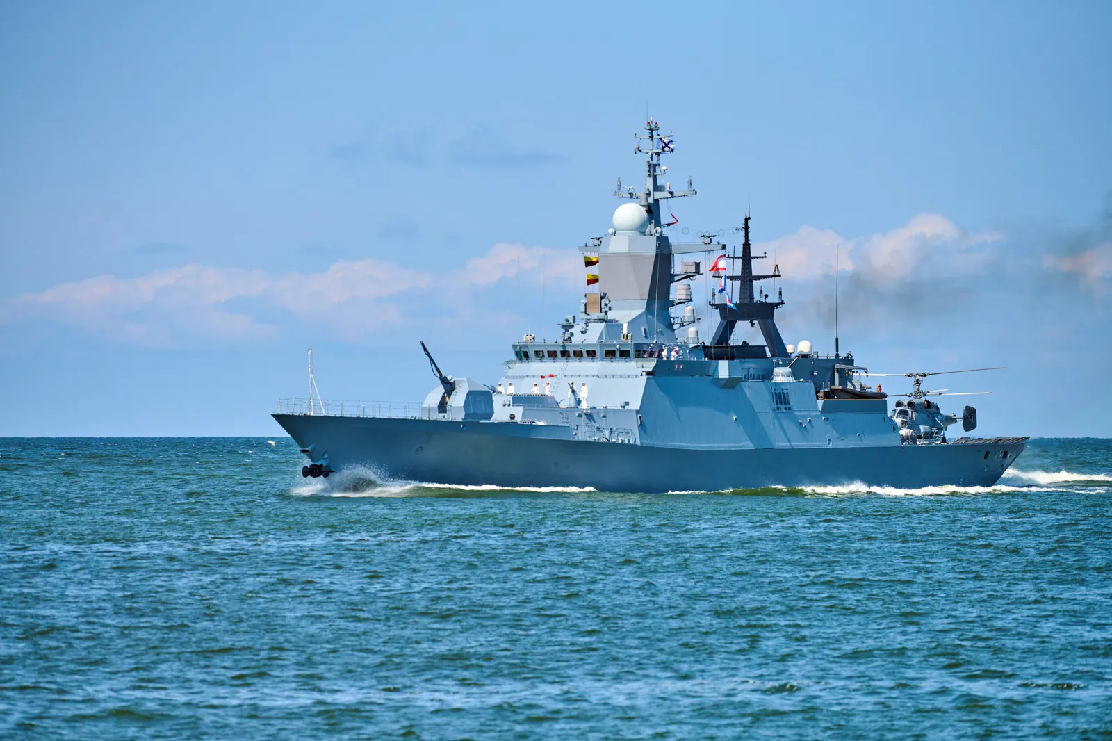 Naval corvette with helicopter at sea