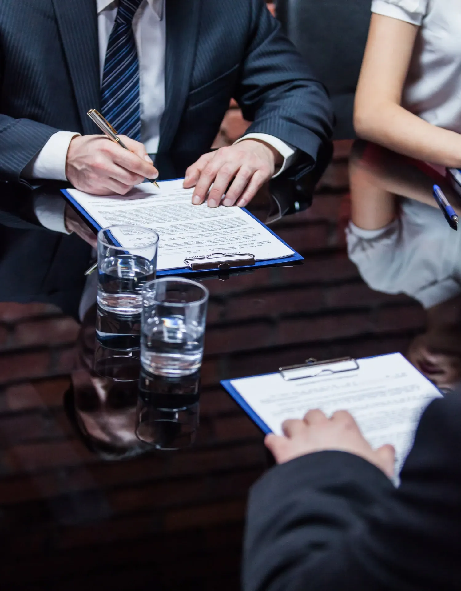 Contract documents signed at a meeting table
