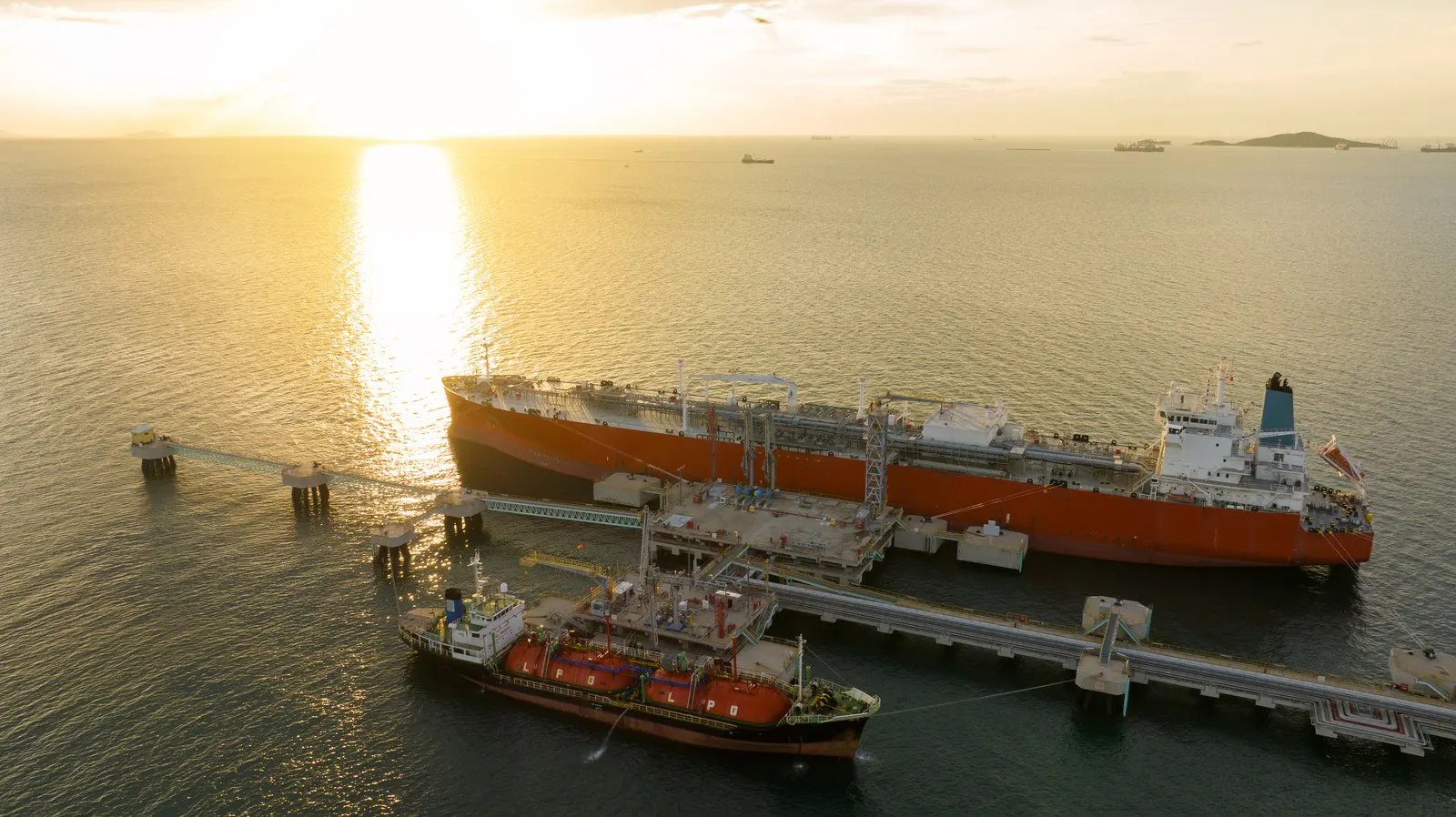 Tanker alongside a jetty at sunset