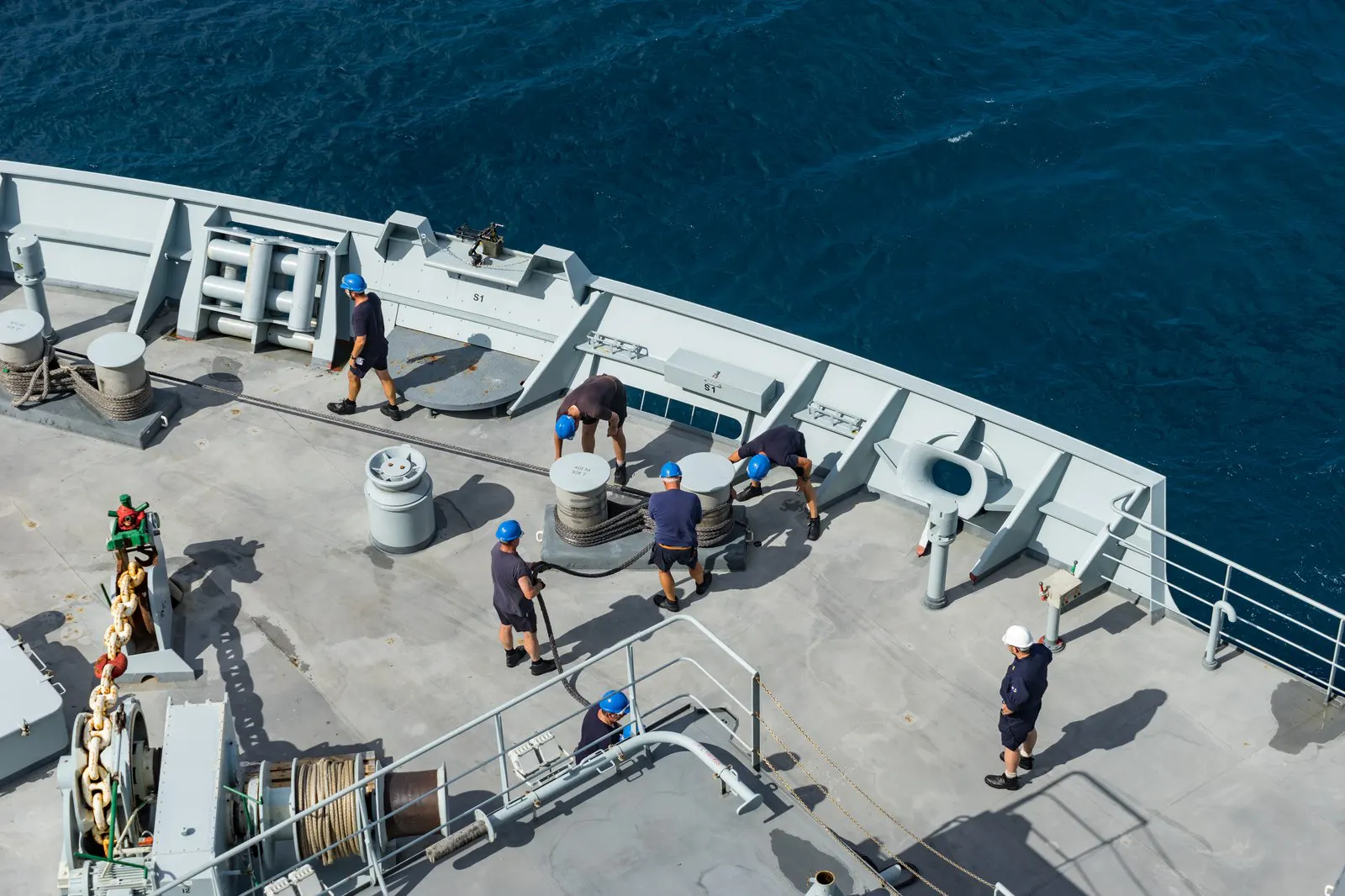 Crew members working on the deck of a vessel at sea