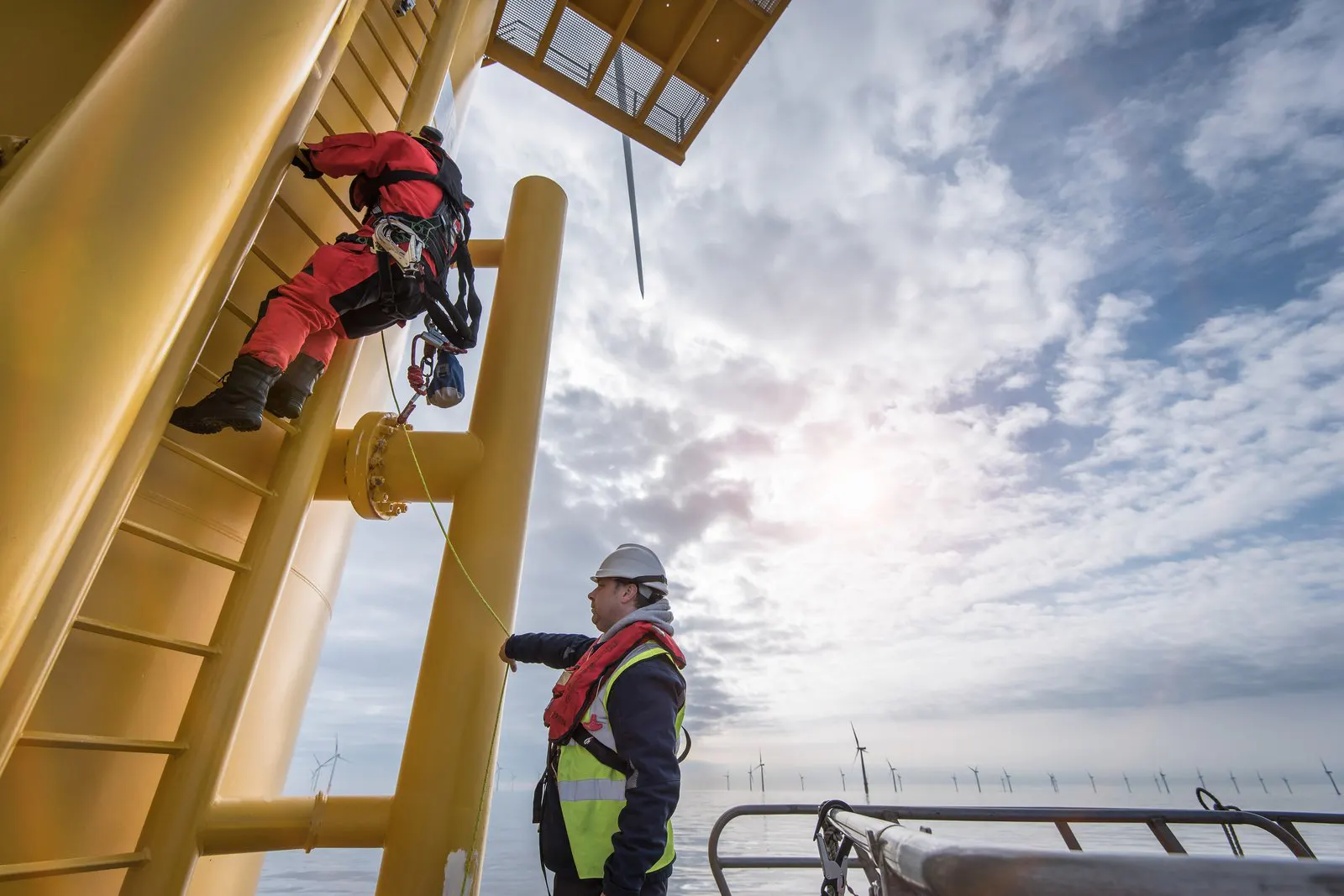 A worker climbing an offshore structure