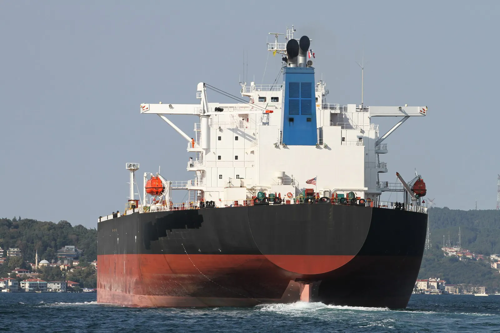 Large cargo ship at sea on a clear sunny day