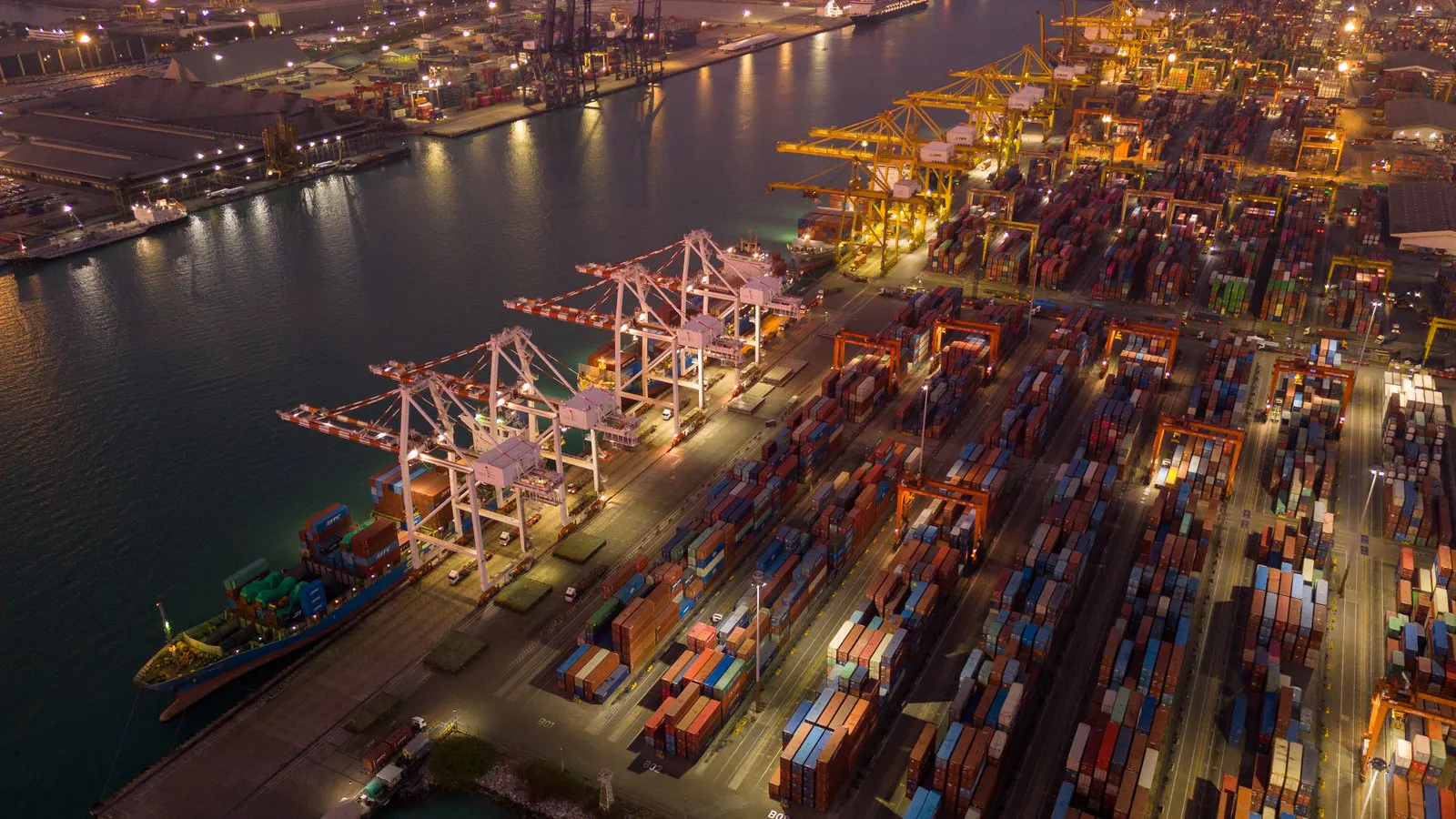 Container terminal and shipyard cranes at dusk