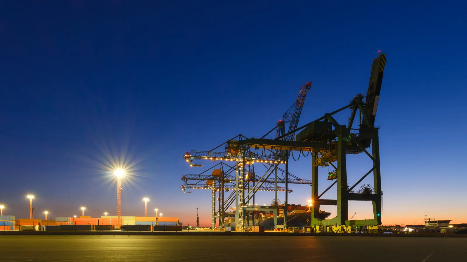 Container terminal cranes at dusk