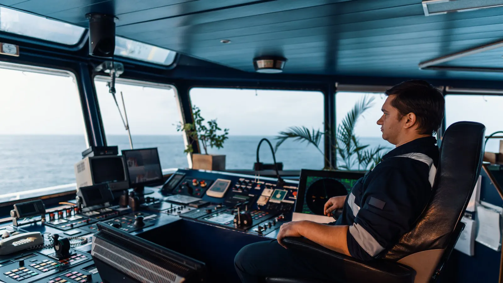 Deck officer keeping watch on a ship's navigation bridge