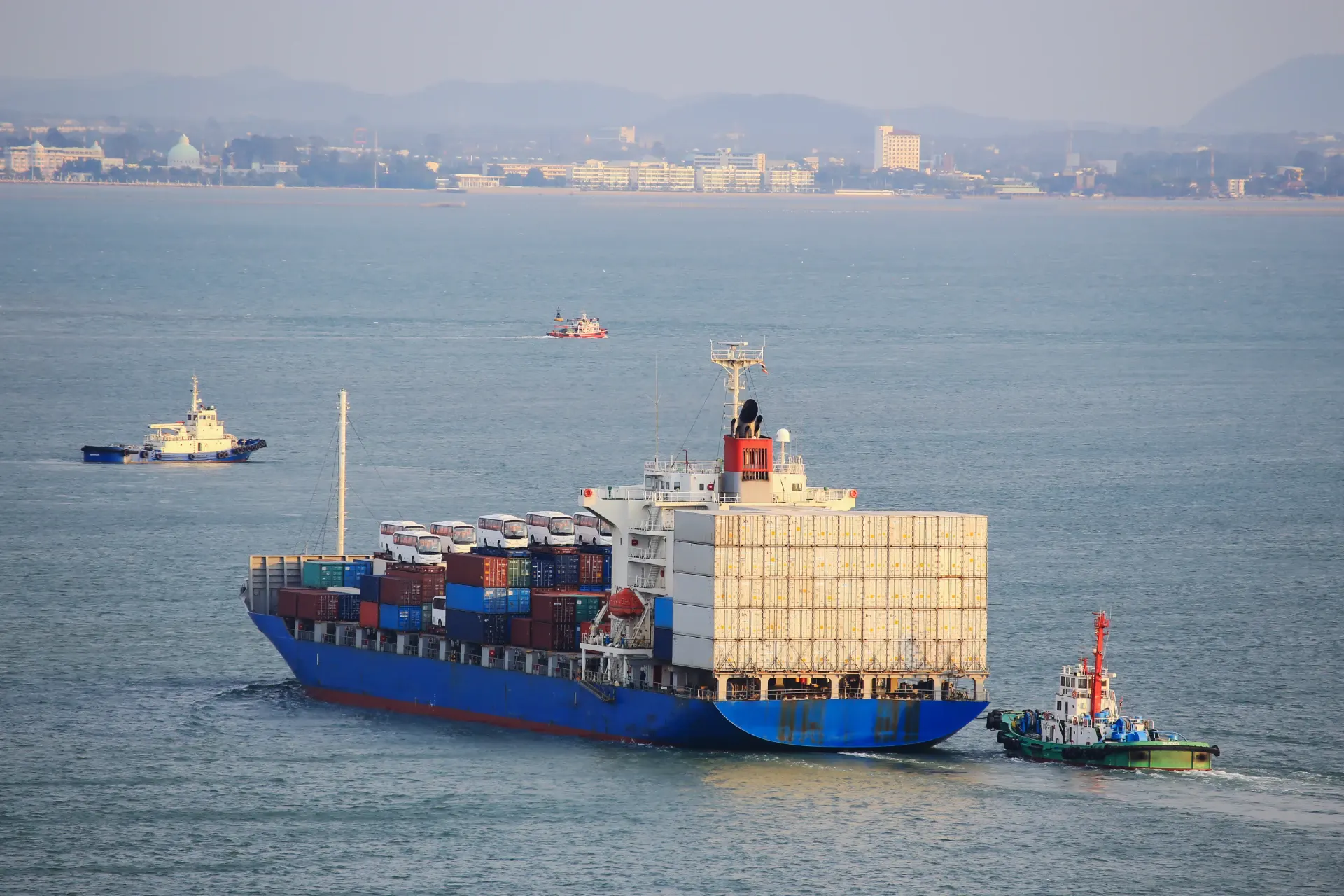 A container ship under way with a full deck load of boxes