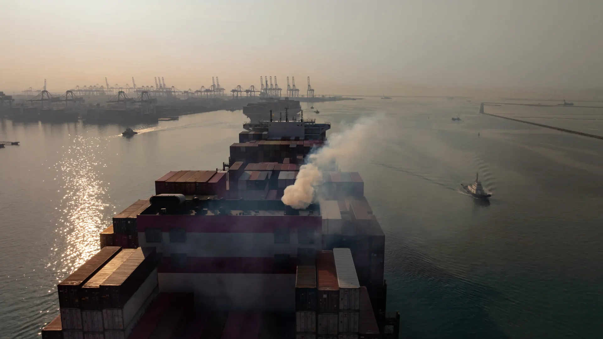 Aerial view container cargo ship with smoke exhaus