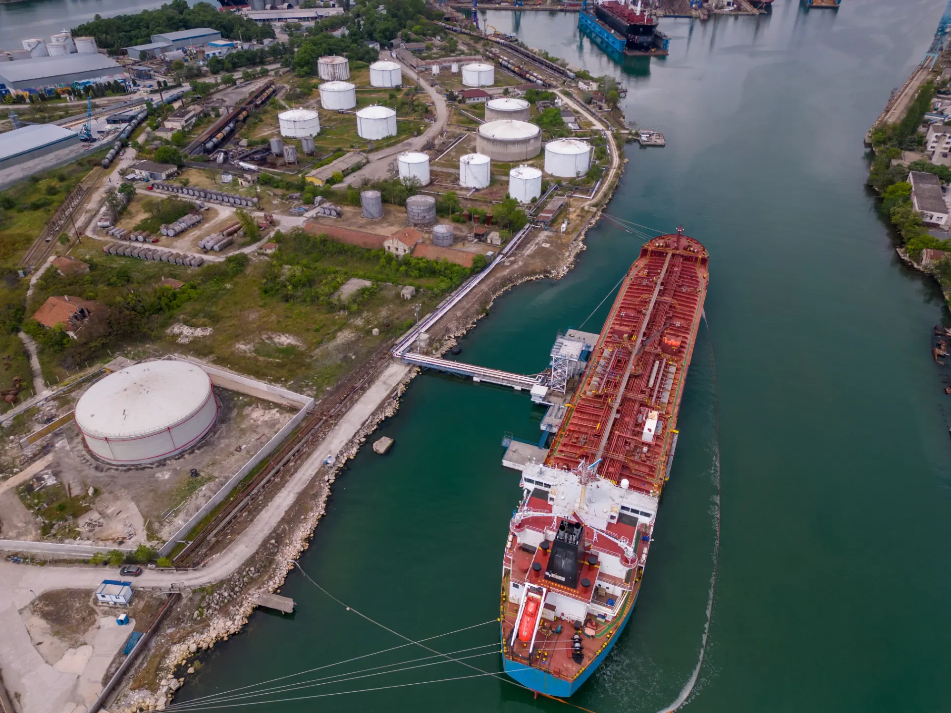 A gas carrier and a tanker at an industrial terminal