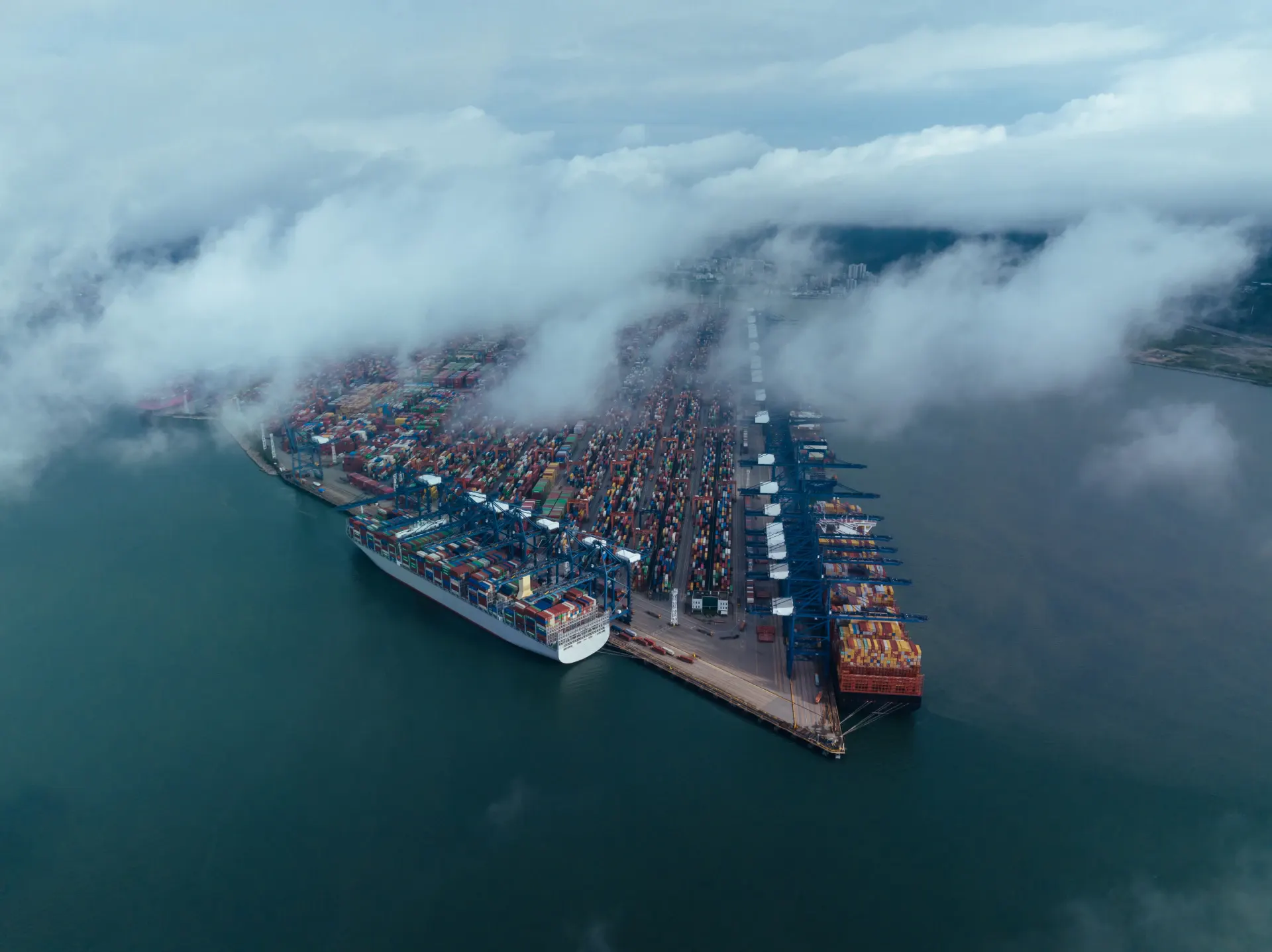 Aerial view of a busy container terminal with vessels alongside