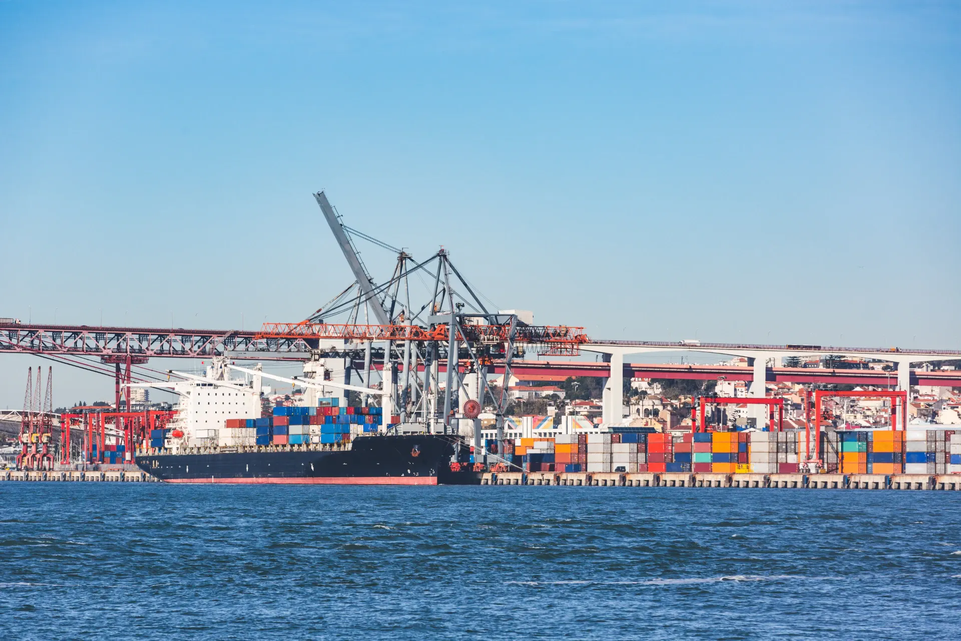 Container ship loading at a terminal, illustrating global terminal operations