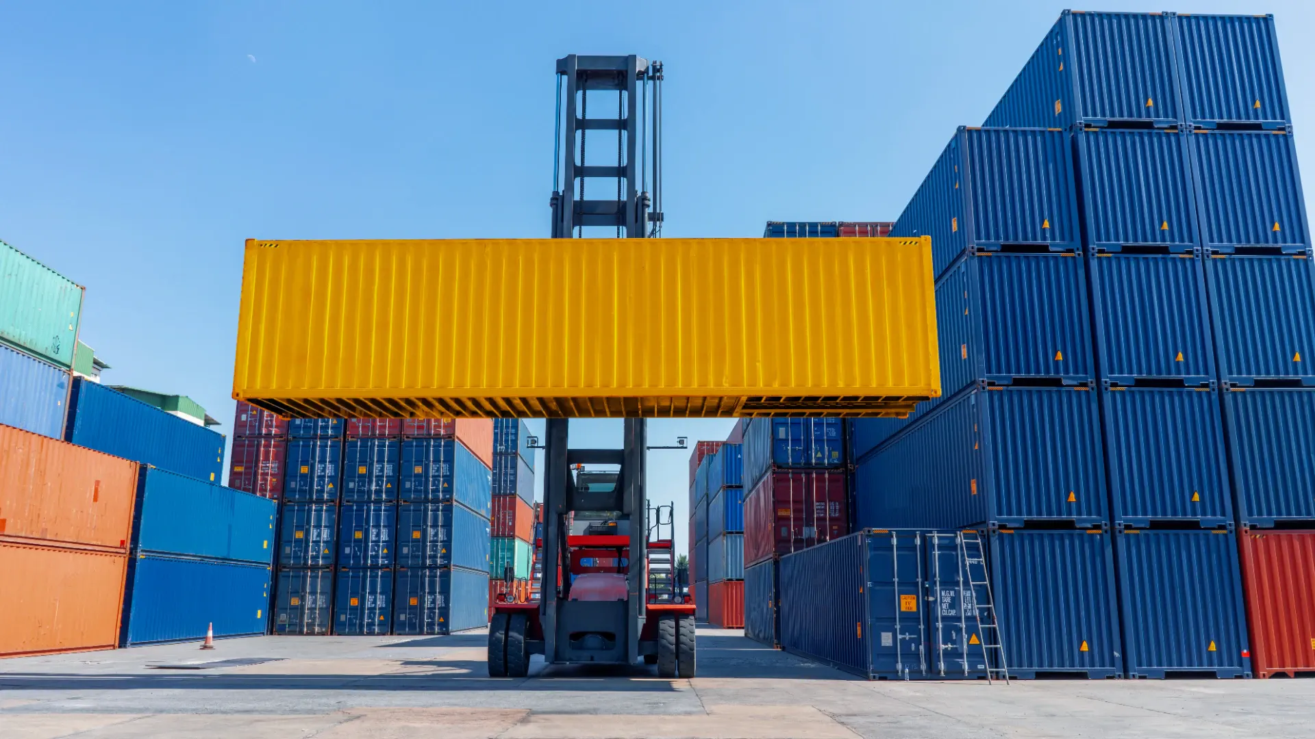 Forklift moving cargo in a container yard