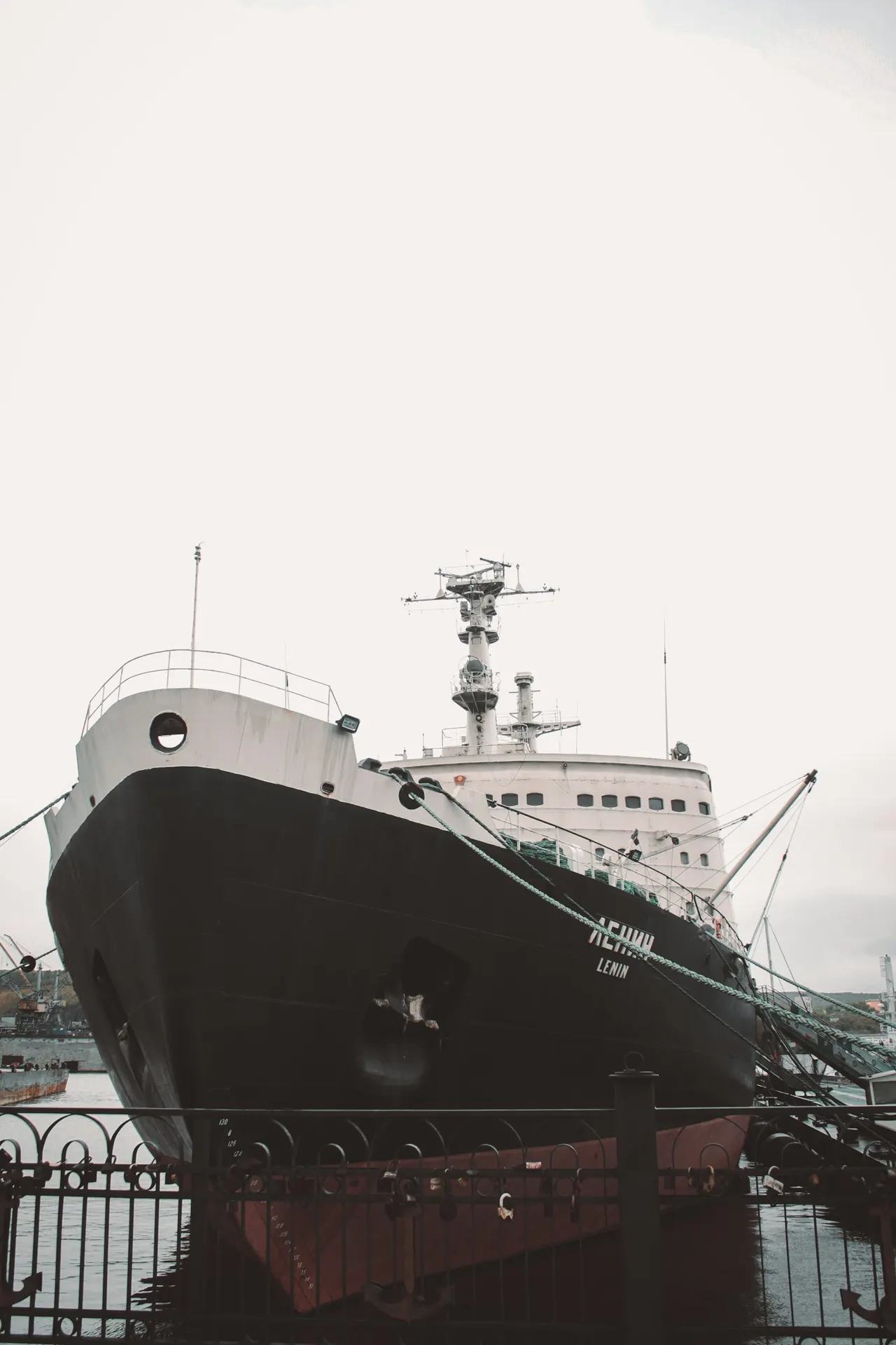 Large naval support vessel alongside at a dock