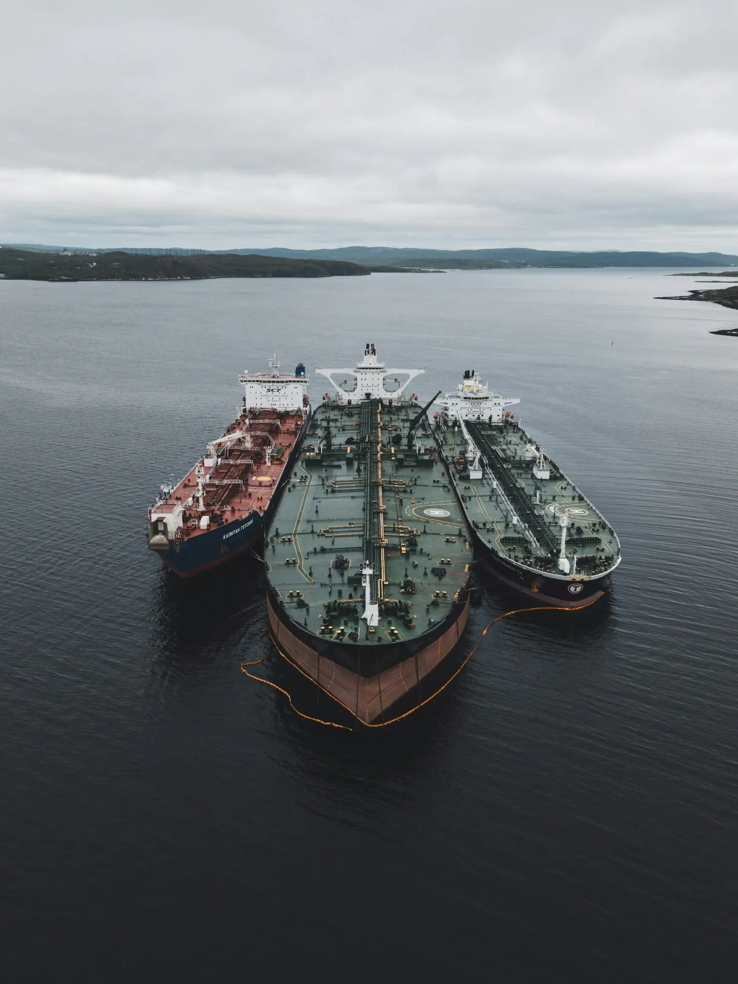 Cargo ships at sea under a cloudy sky